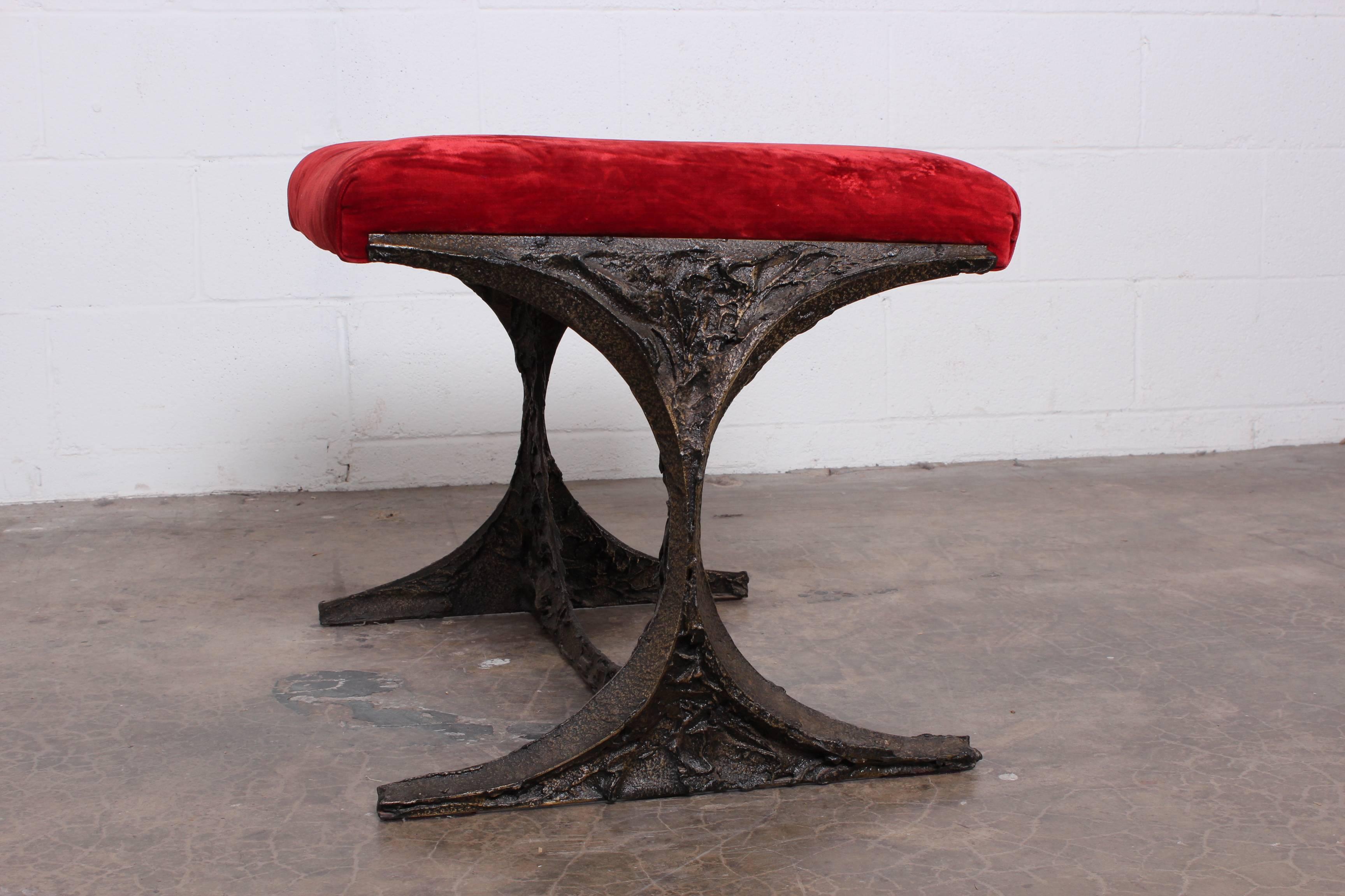 A sculpted bronze stool designed by Paul Evans in original red velvet.