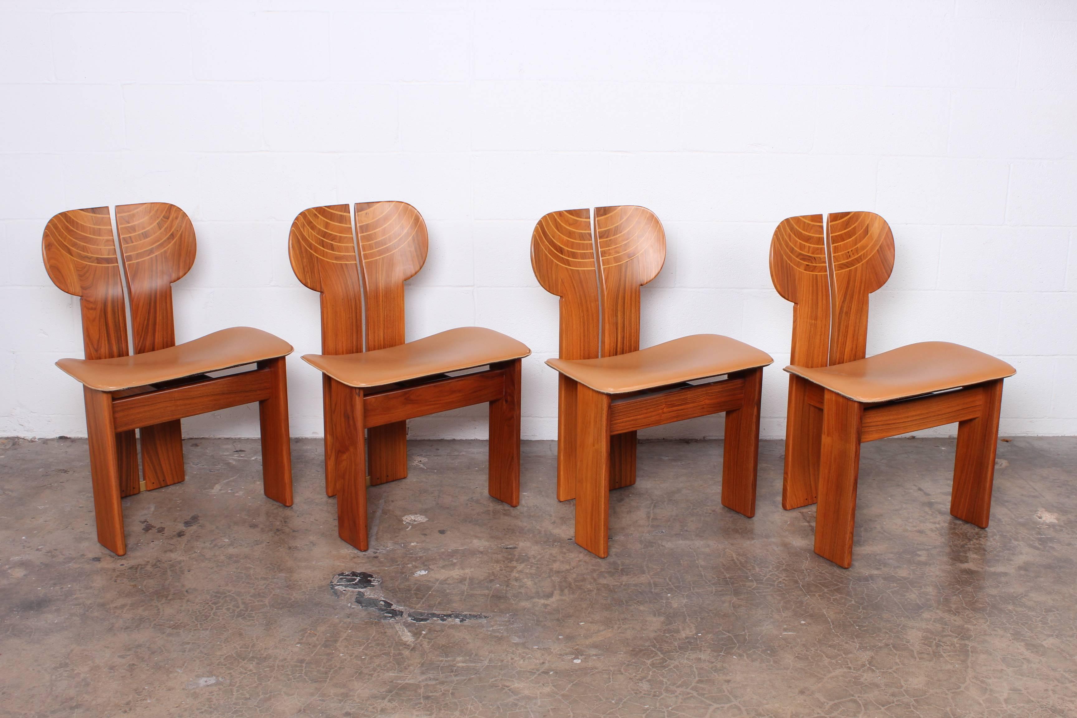 A set of four Africa chairs in pallisander, ebony, leather and brass. Designed by Afra & Tobia Scarpa for Maxalto.