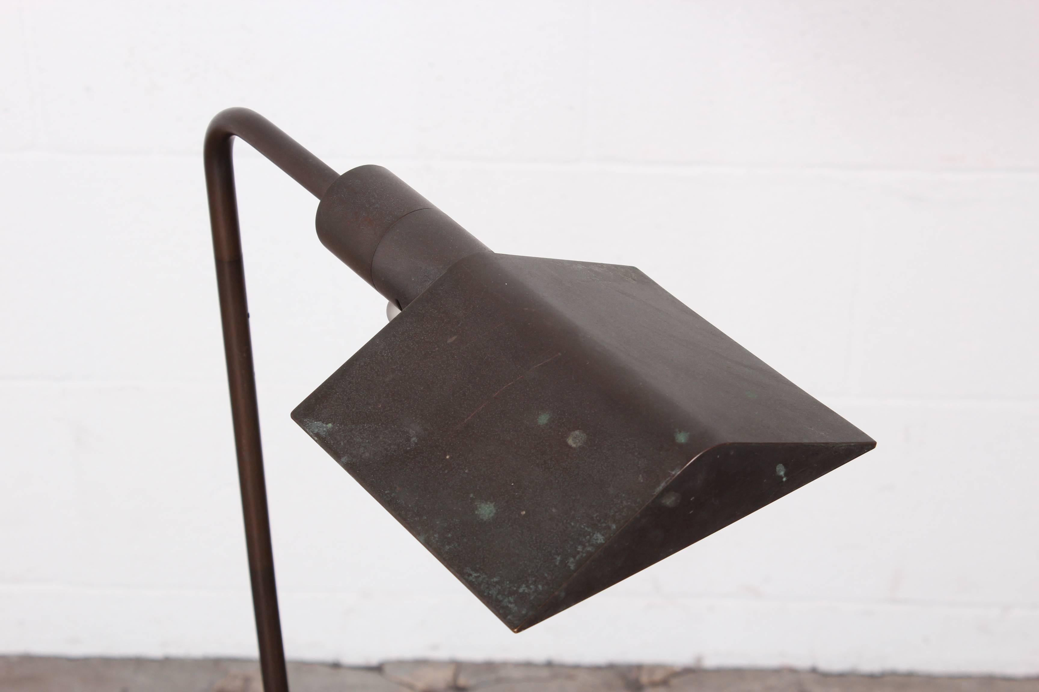 A signed Cedric Hartman floor lamp with a raw patinated bronze finish.