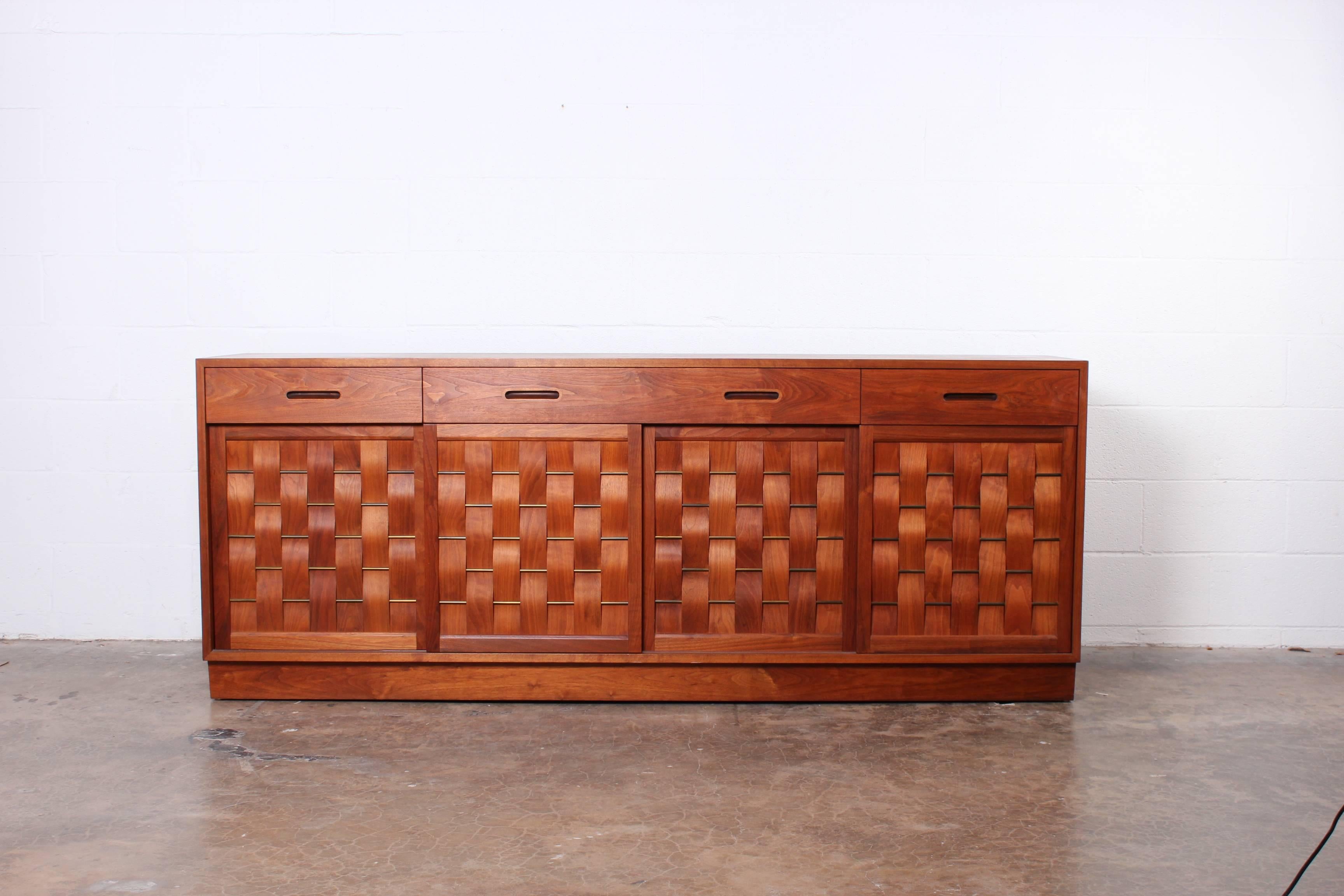 A bleached walnut woven front credenza designed by Edward Wormley for Dunbar.