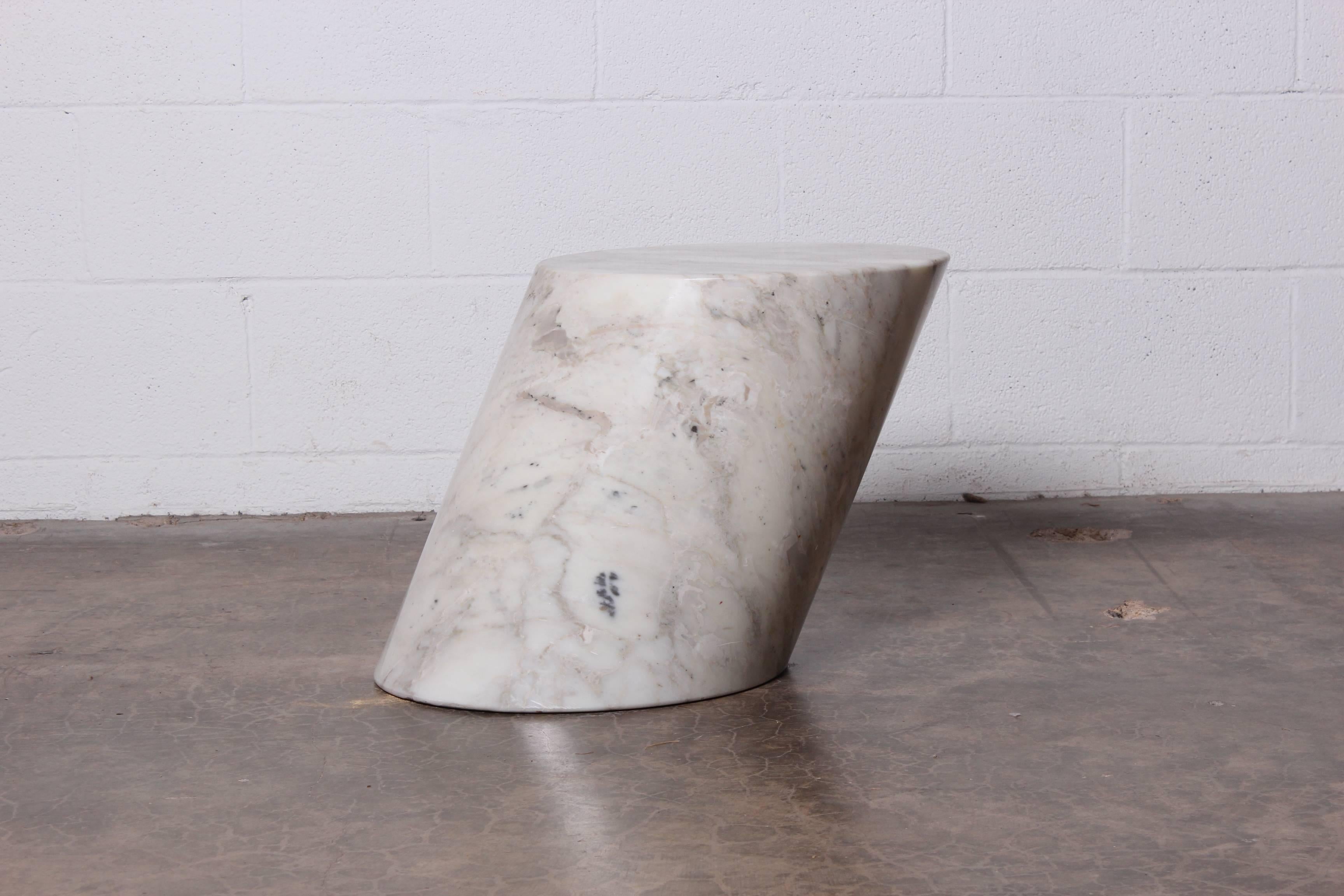 A solid marble stump table designed by Lucia Mercer for Knoll.