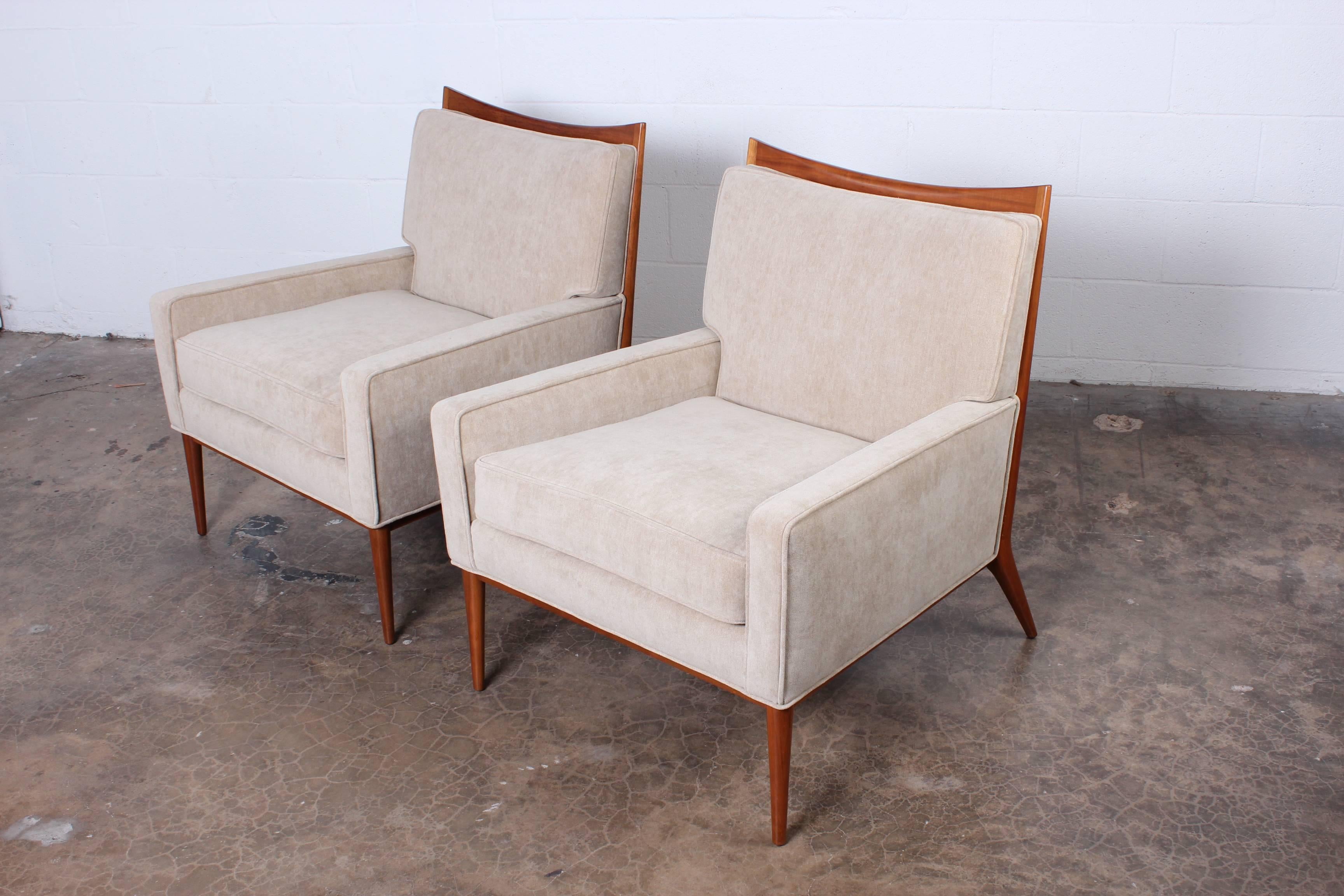 A pair of fully restored lounge chairs designed by Paul McCobb for directional. Reupholstered in Holly Hunt 
