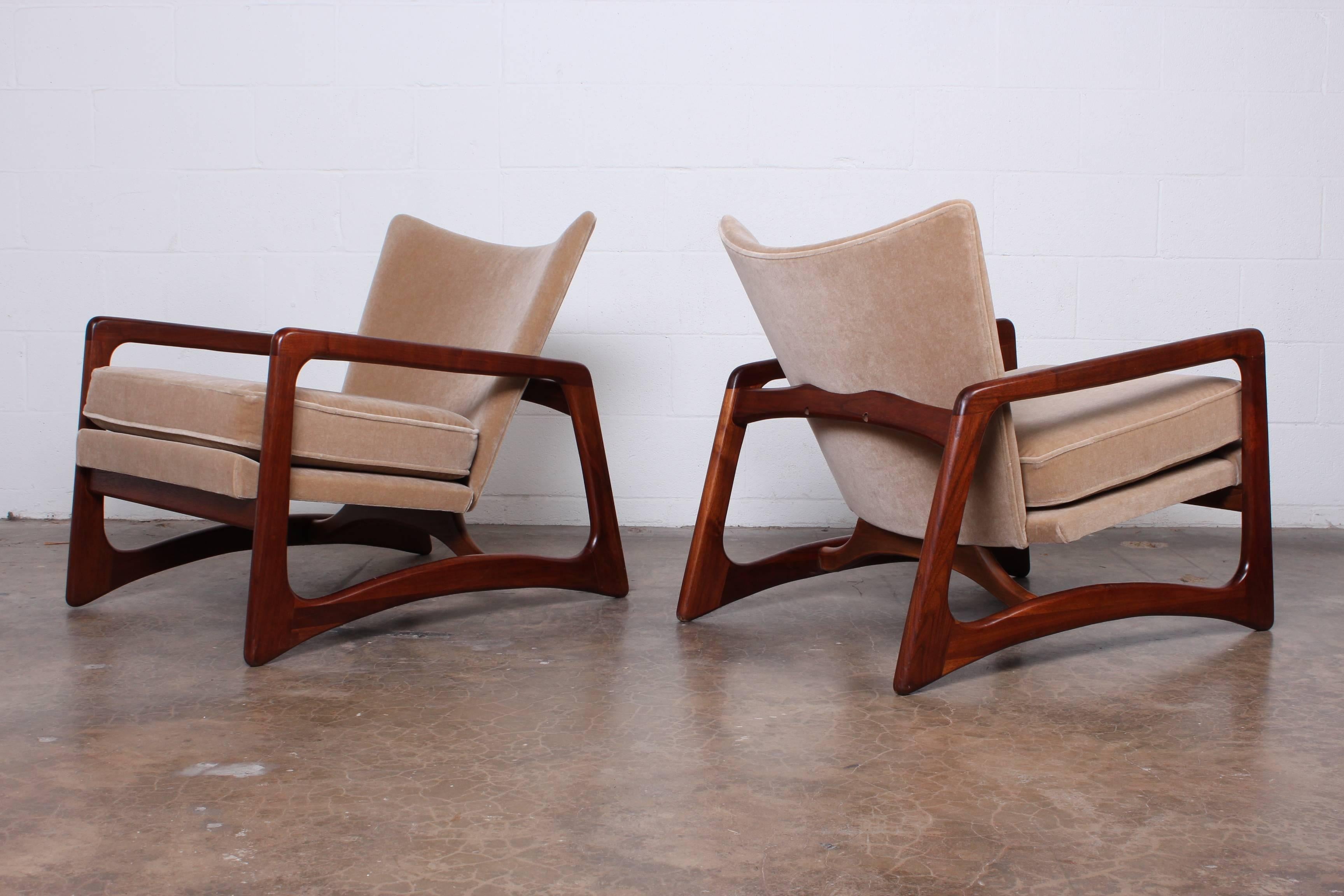 A pair of walnut and mohair lounge chairs by Adrian Pearsall for Craft Associates.