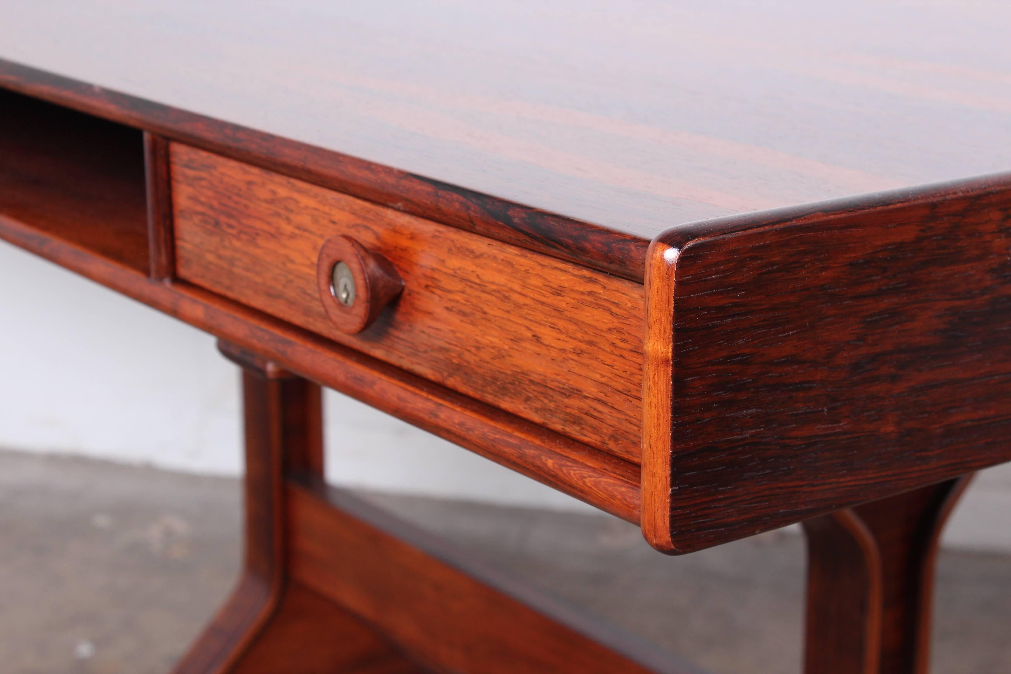 A rosewood desk designed by Gianfranco Frattini for Bernini.