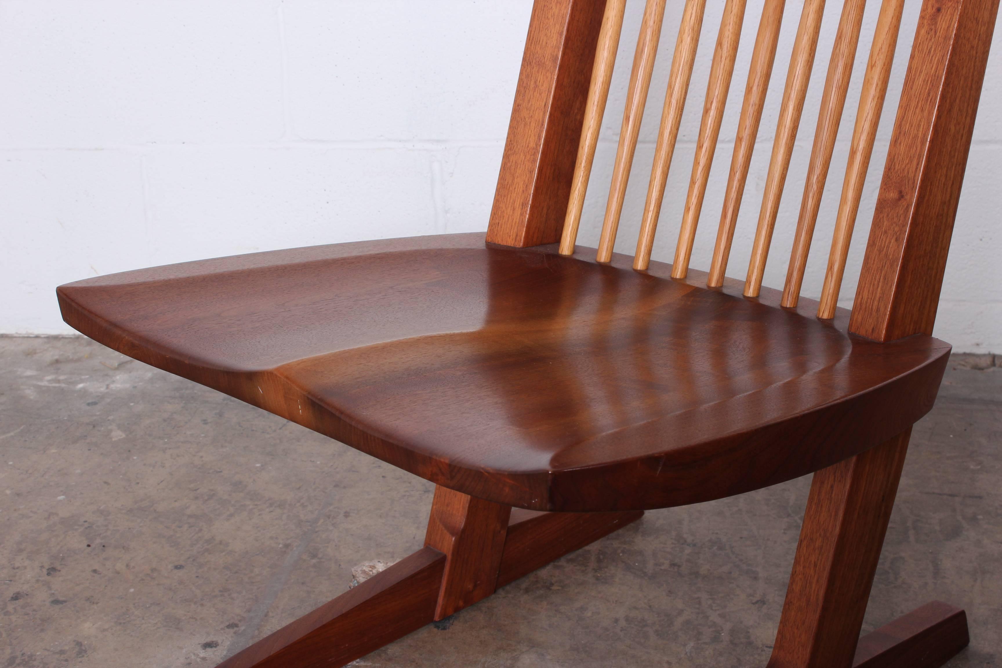 A rare pair of walnut Conoid lounge chairs by George Nakashima. These chairs are signed and dated June 4, 1990. These are some of the last pieces George completed before passing away on June 15, 1990.