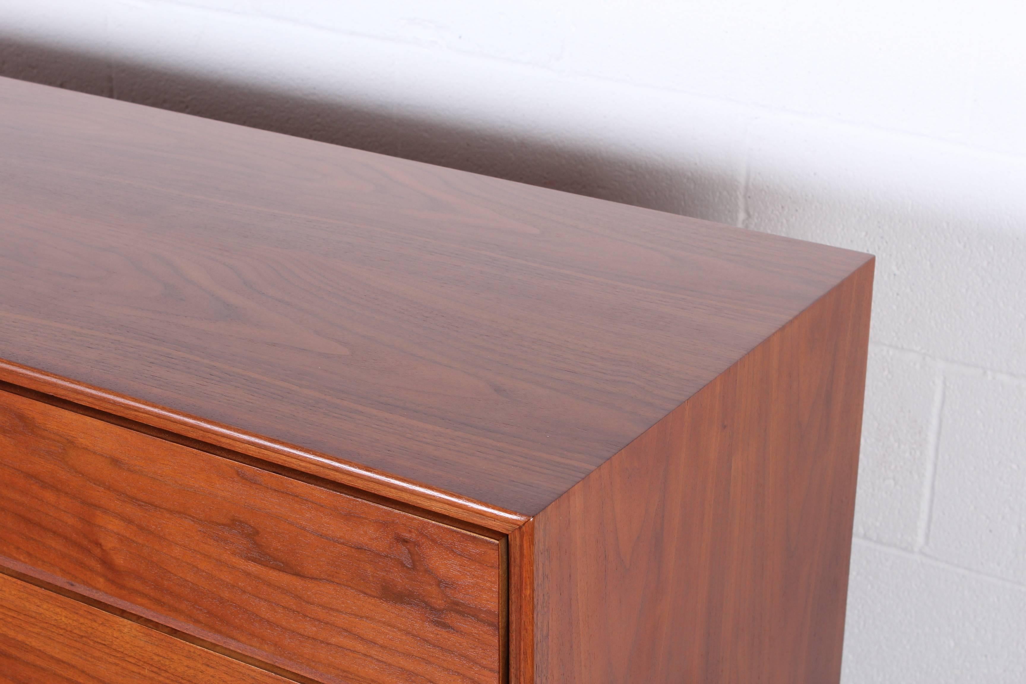 A walnut dresser with leather pulls. Designed by Edward Wormley for Dunbar.