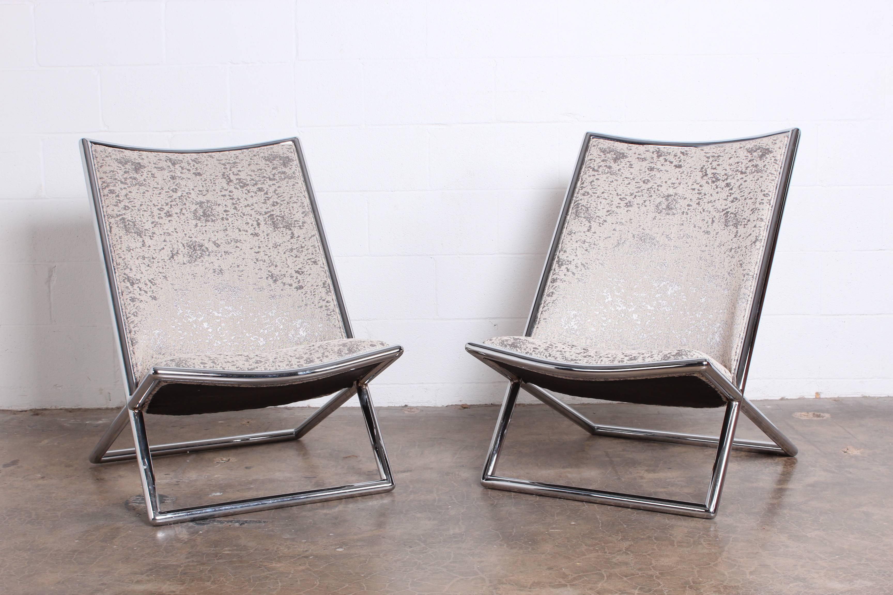 A pair of chrome scissor chairs designed by Ward Bennett for Brickel.