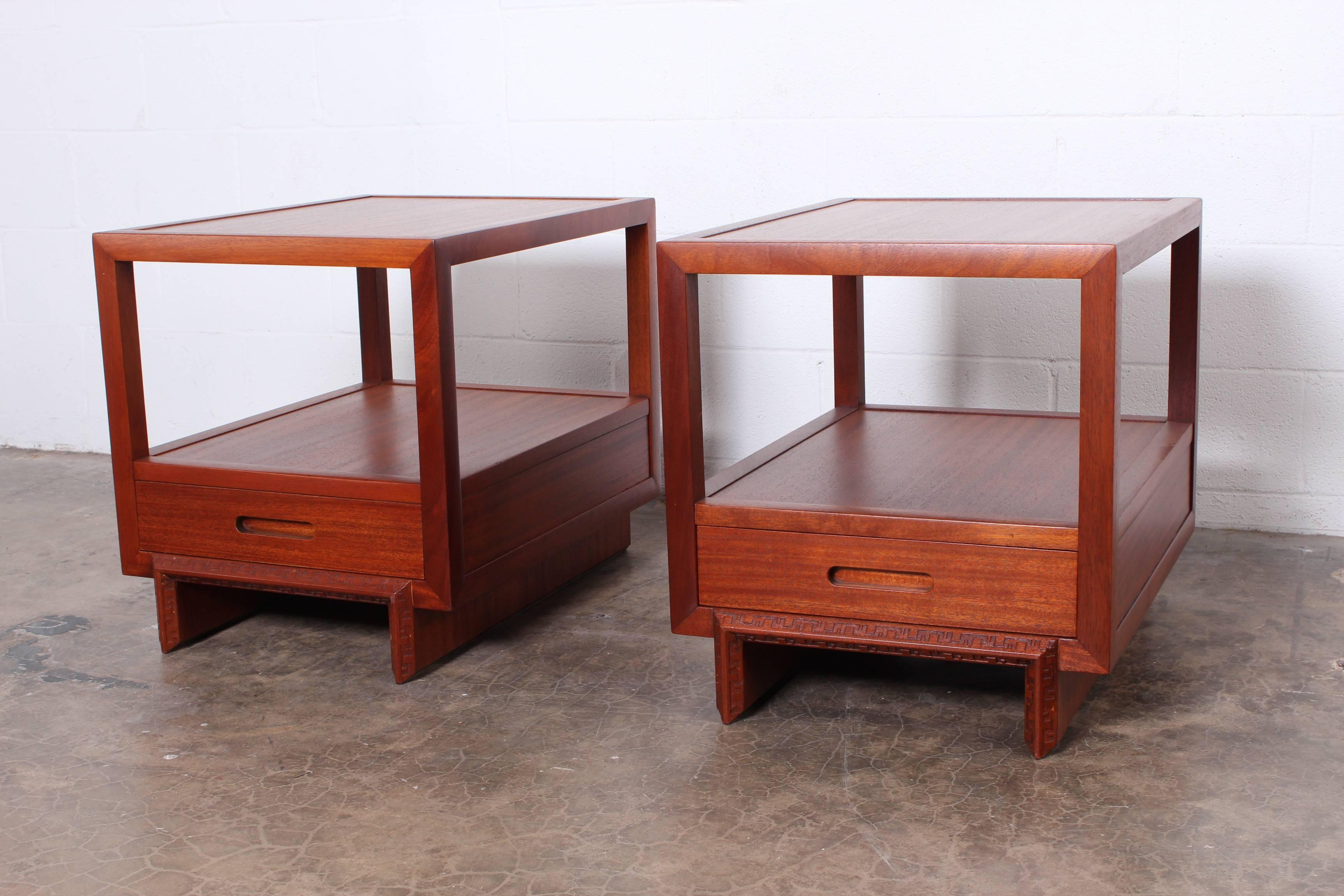 A pair of mahogany nightstands or end tables designed by Frank Lloyd Wright for Heritage Henredon.