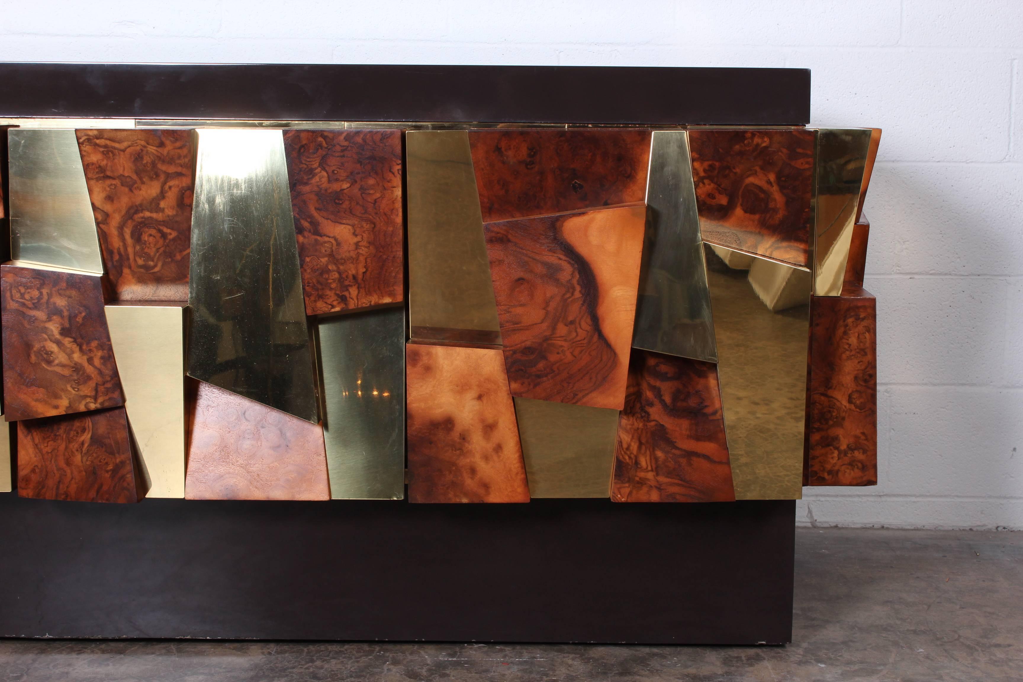 A large burl and brass faceted credenza designed by Paul Evans. Matching dining table also available.