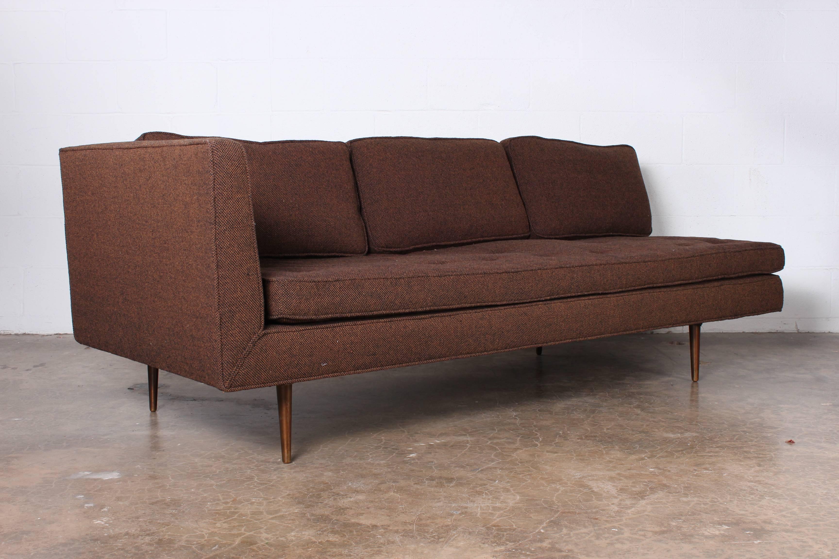 A one armed sofa or chaise with brass legs. Designed by Edward Wormley for Dunbar.
