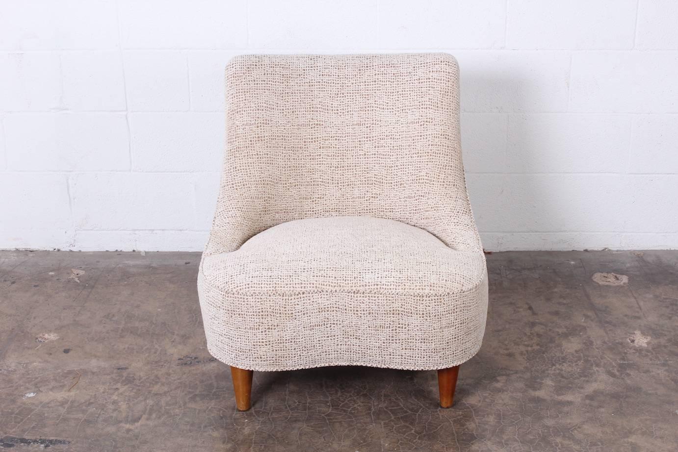 An elegant tear drop slipper chair designed by Edward Wormley for Dunbar.