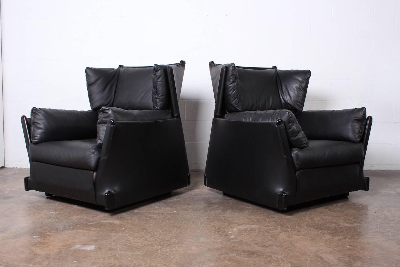 A rare and extremely comfortable pair of large black leather Viola d'Amore armchairs (#104) designed by Piero De Martini for Cassina. These chairs were purchased directly from Italy by the original owner.