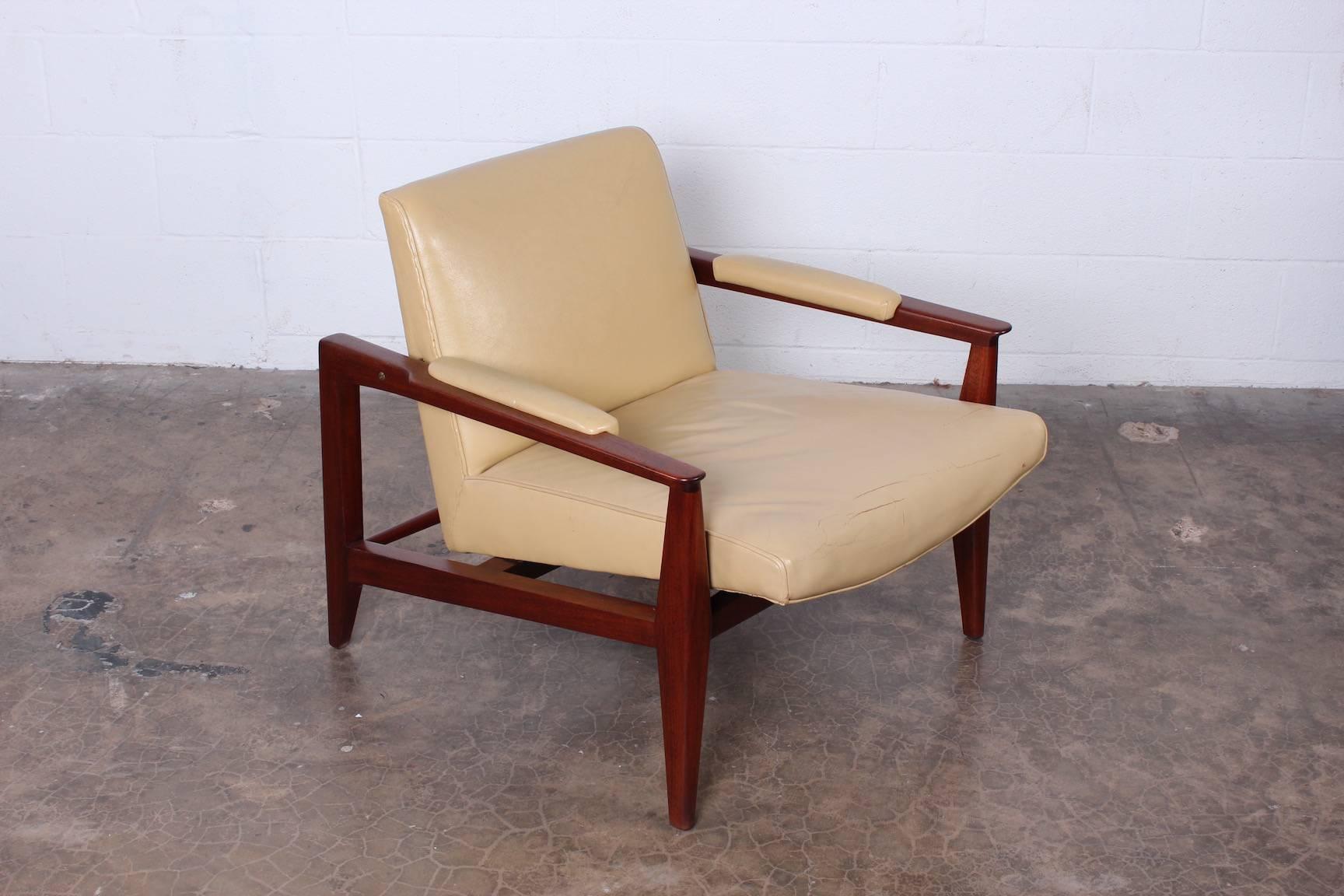 A mahogany lounge chair with original leather upholstery. Designed by Edward Wormley for Dunbar.