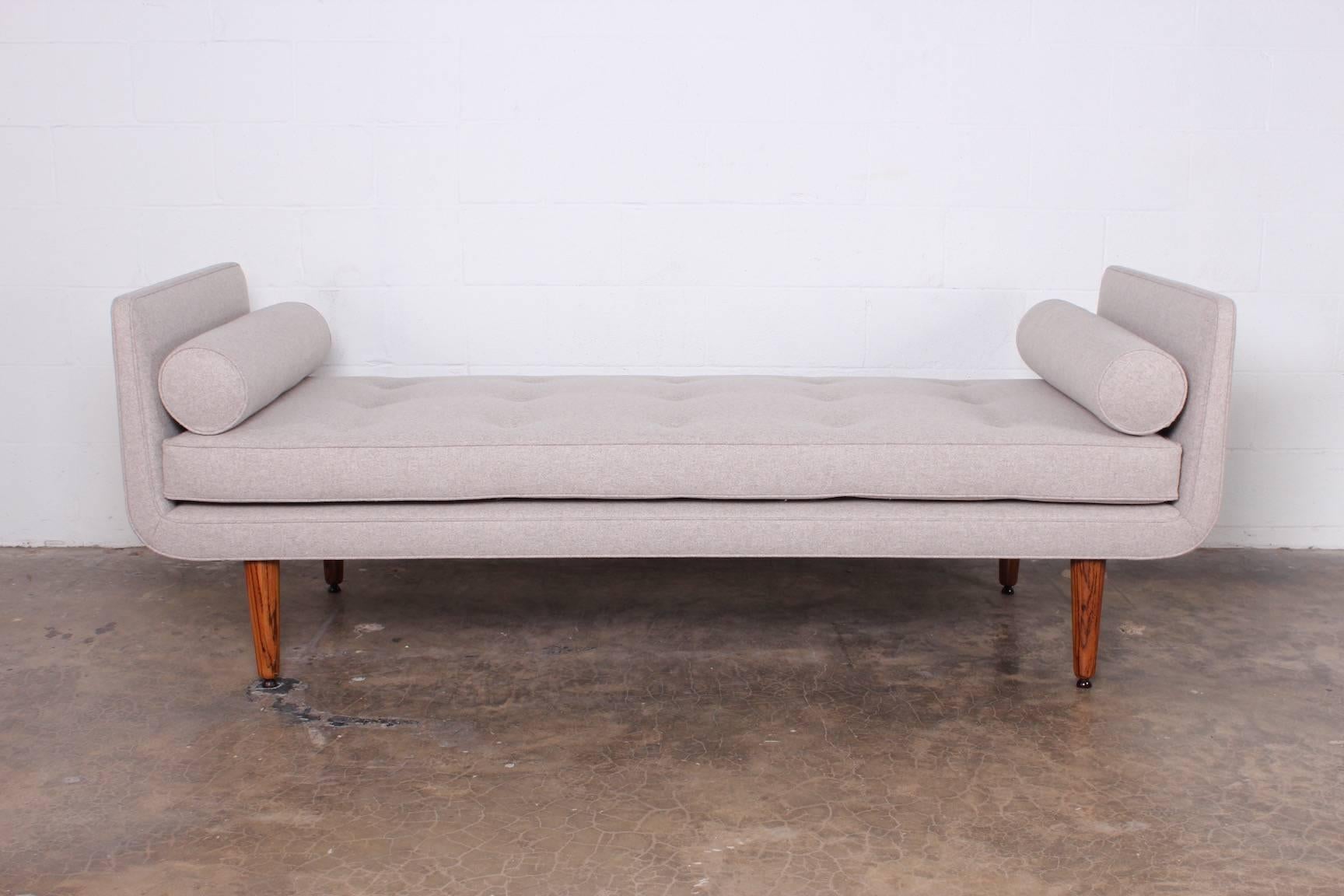 An early Dunbar daybed or bench on rosewood legs. Designed by Edward Wormley. Newly upholstered in wool fabric.