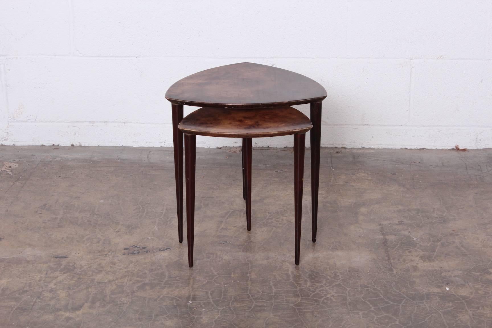 A pair of triangular goatskin covered nesting tables by Aldo Tura.