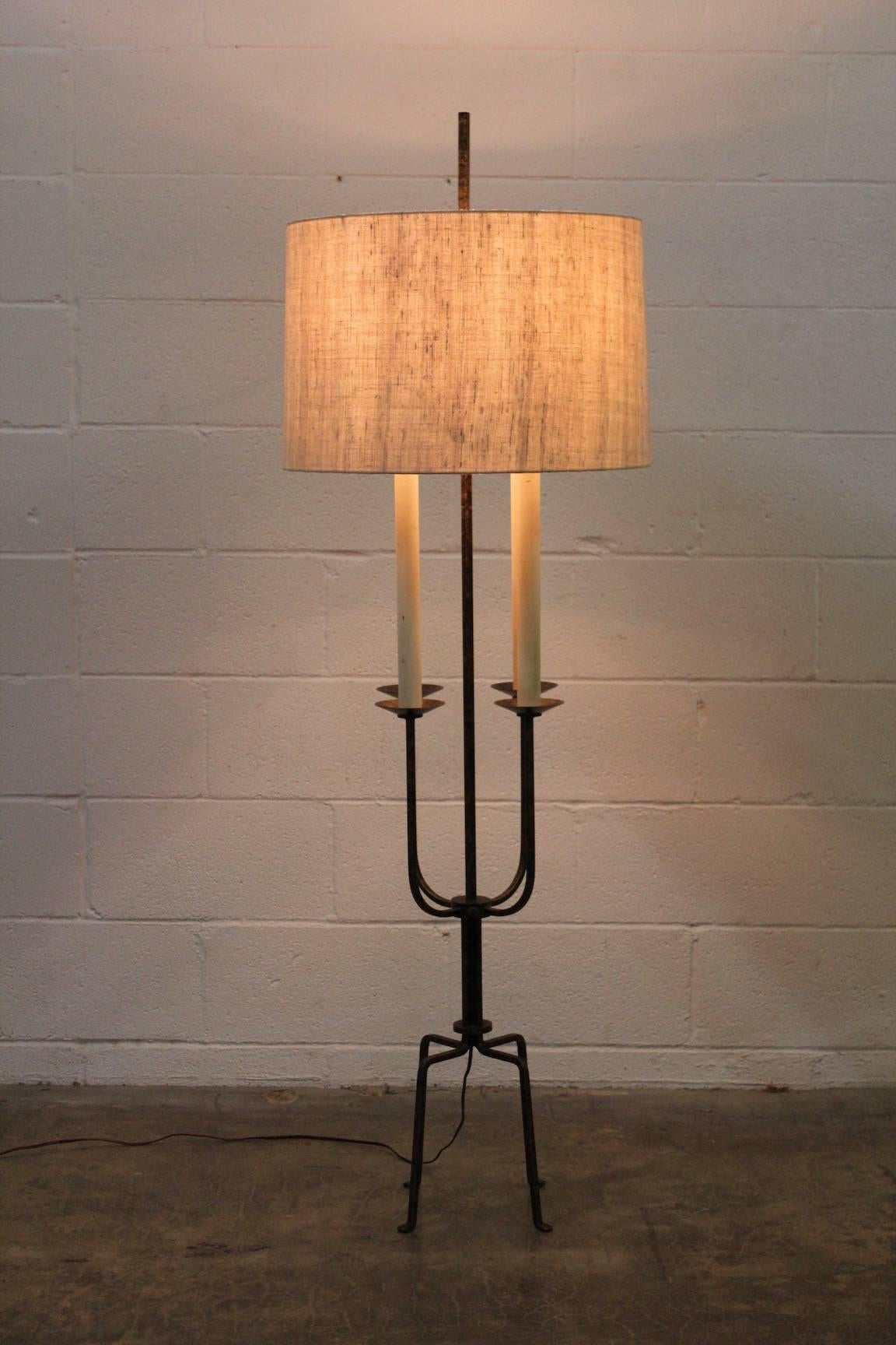 A gilt-iron floor lamp with linen shade designed by Tommi Parzinger for Parzinger originals. Original finish and new shade.