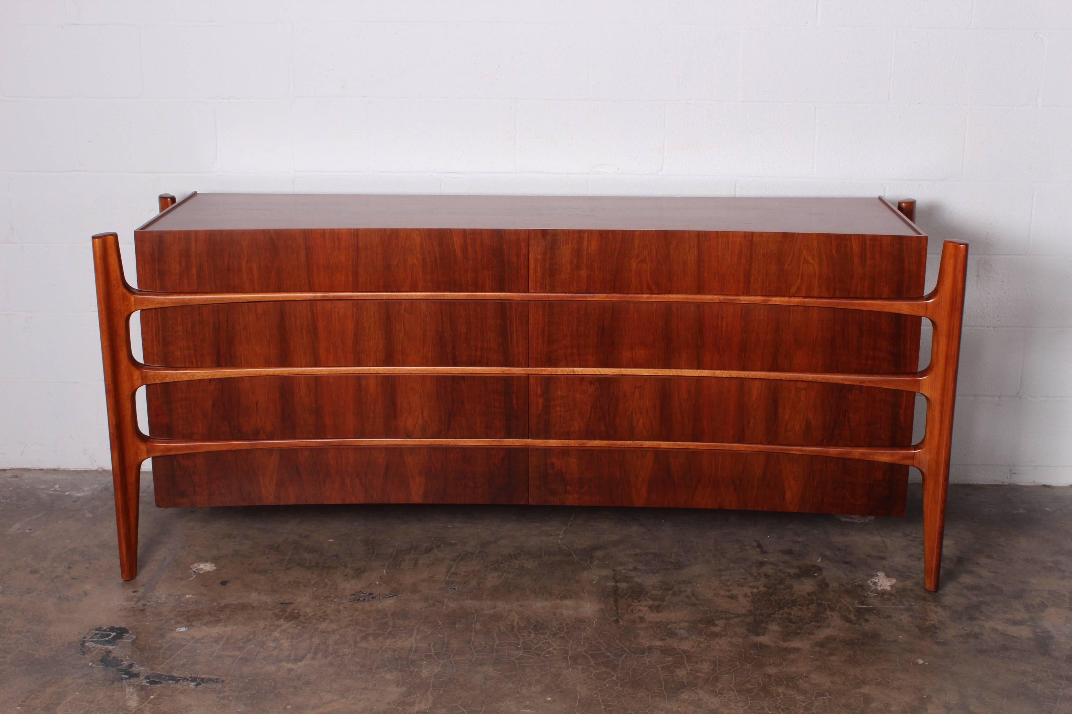 A sculptural walnut eight-drawer dresser designed by William Hinn and made in Sweden by Swedish furniture guild for Urban Furniture.