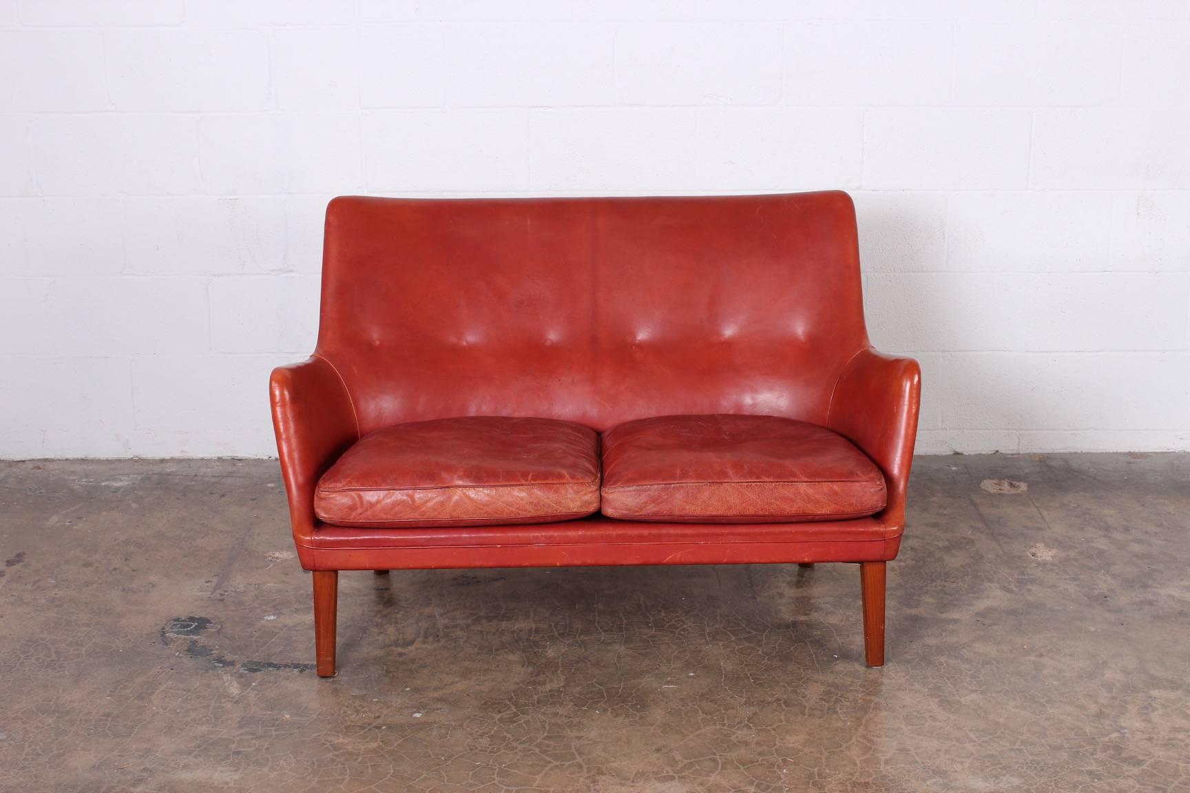 A rare settee designed by Arne Vodder and produced by Ivan Schlechter. Original leather with beautiful patina.