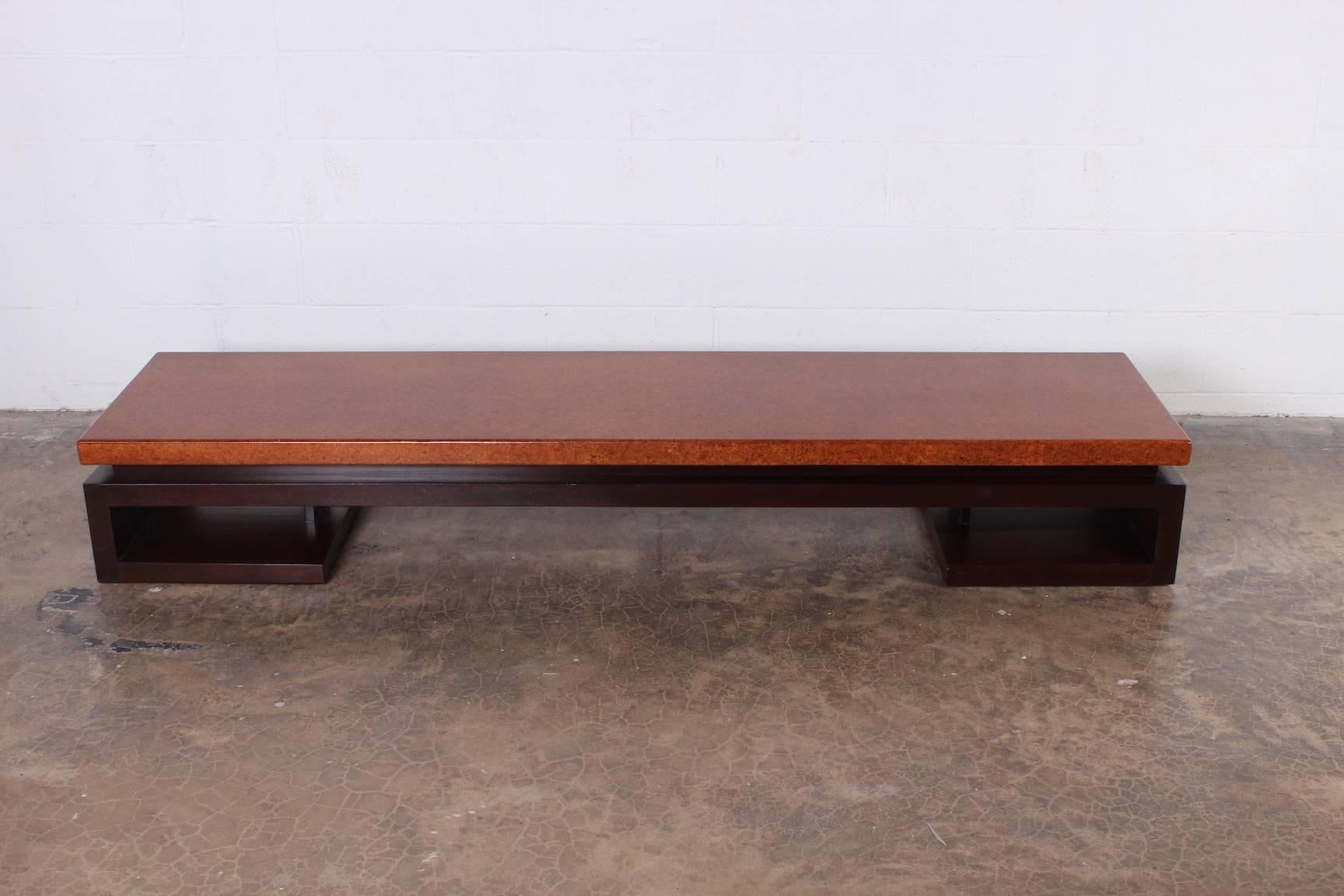 A cork top bench with mahogany base. Designed by Paul Frankl for Johnson furniture.
