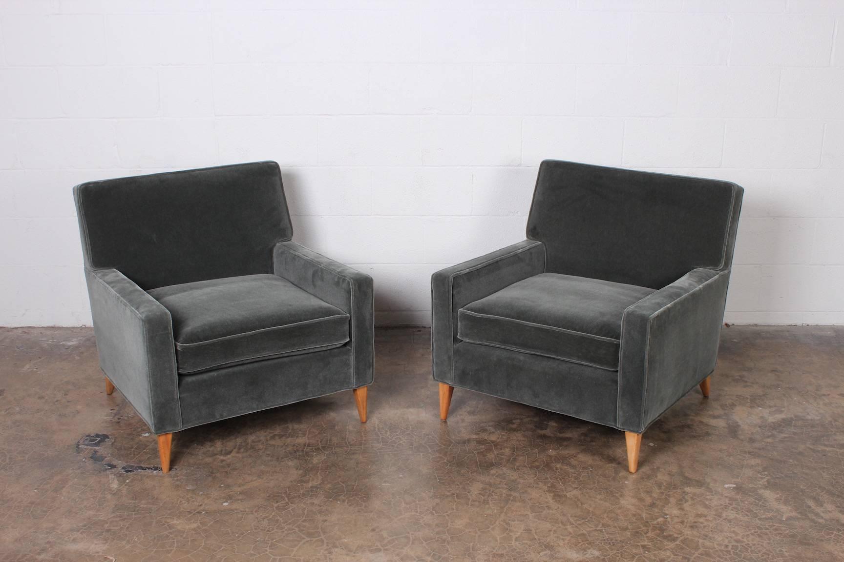 A pair of lounge chairs with maple legs designed by Paul McCobb for Custom Craft. These have been fully restored and upholstered in mohair.