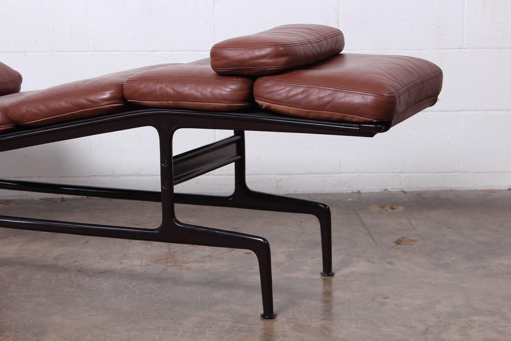 A Billy Wilder chaise in brown leather with eggplant colored frame. Designed by Charles Eames for Herman Miller.
     