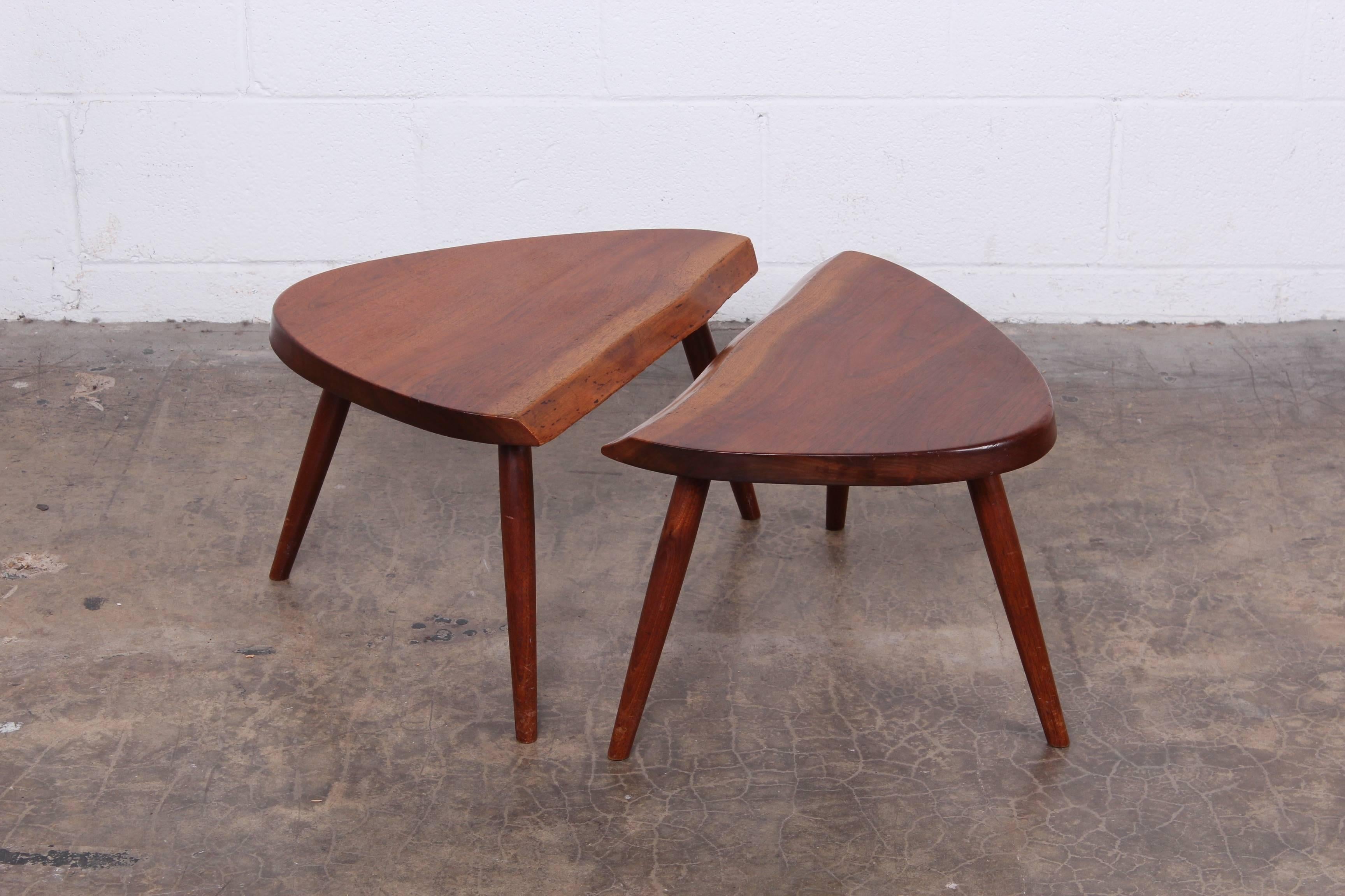 A pair of free edge, sap grain walnut side tables by George Nakashima, 1961. These are sold with a copy of the original order card.