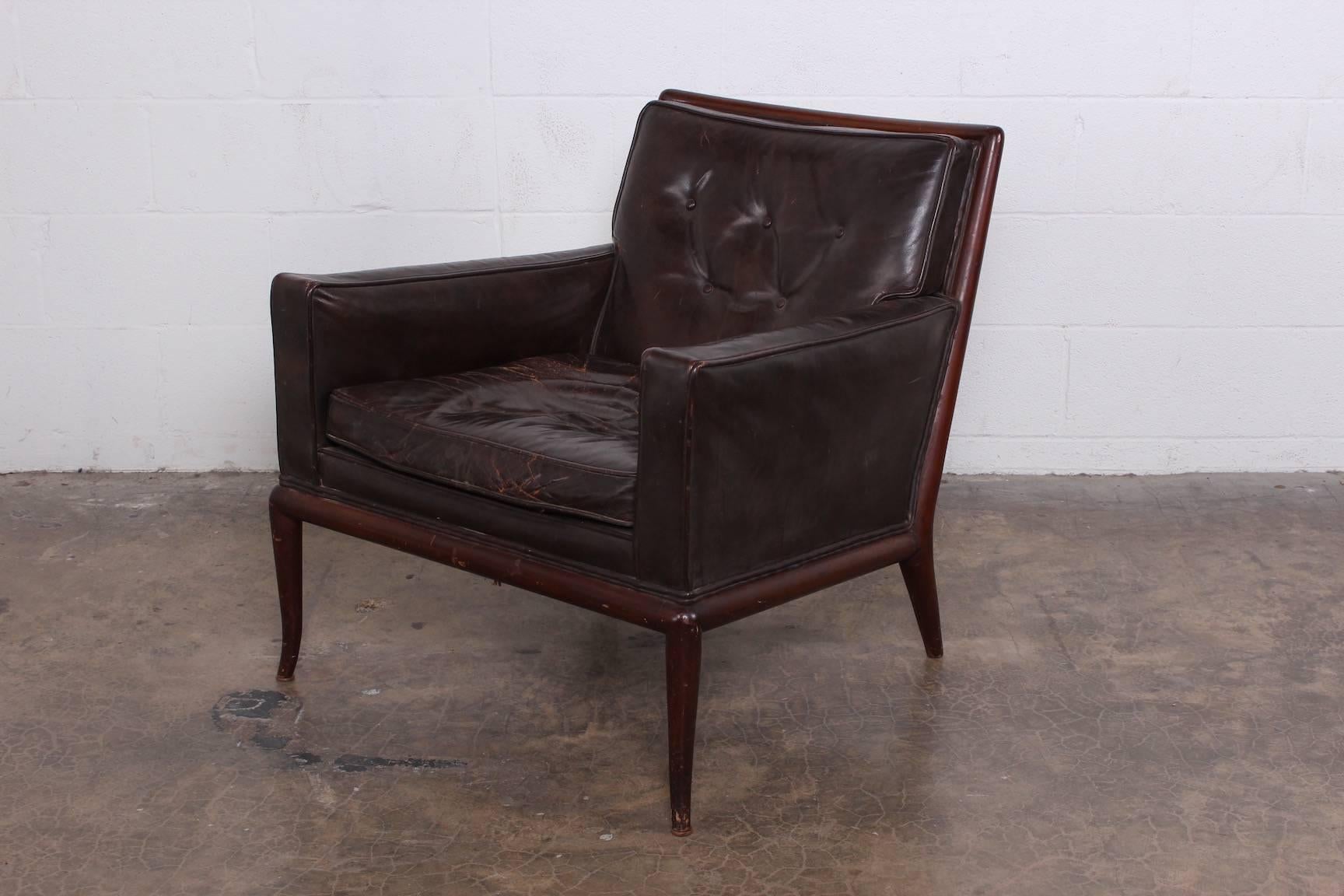 An iconic lounge chair by T.H. Robsjohn-Gibbings for Widdicomb in original, beautifully patinated brown leather.