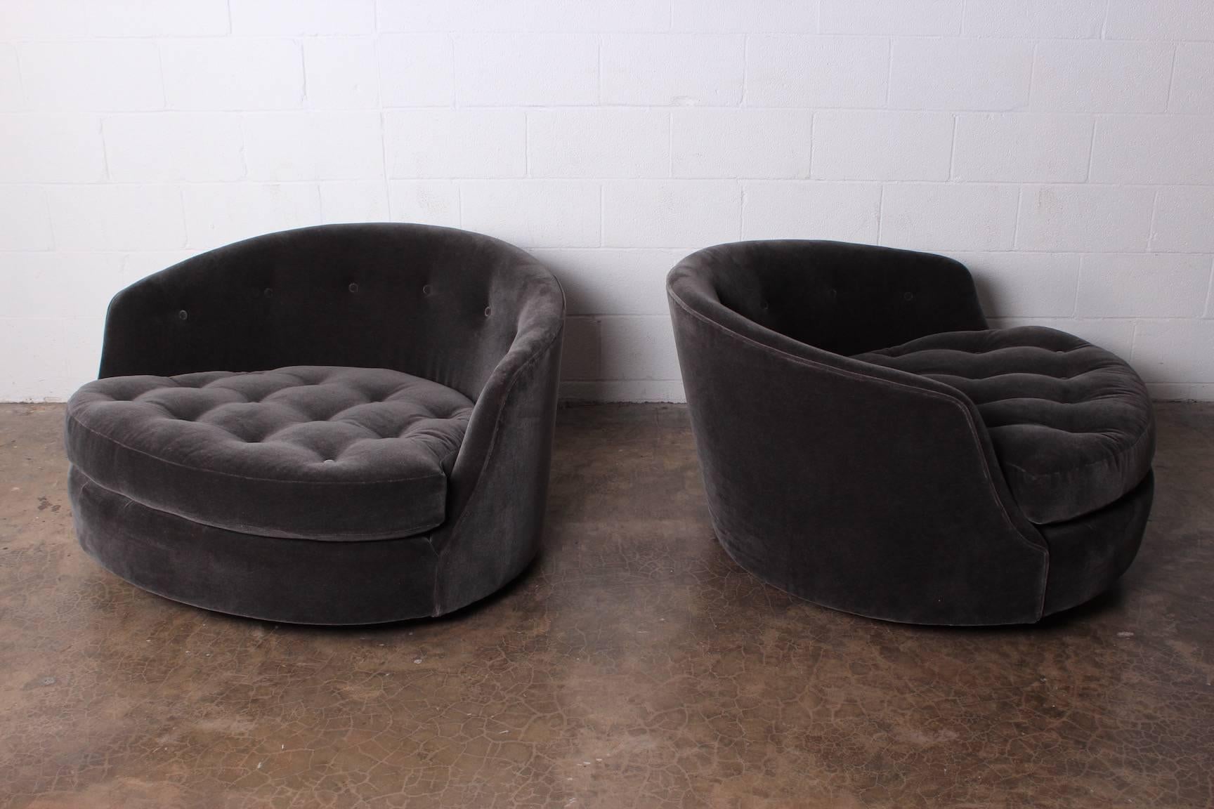 A pair of oversized swivel chairs on walnut bases newly upholstered in mohair. Designed by Milo Baughman for Thayer Coggin.