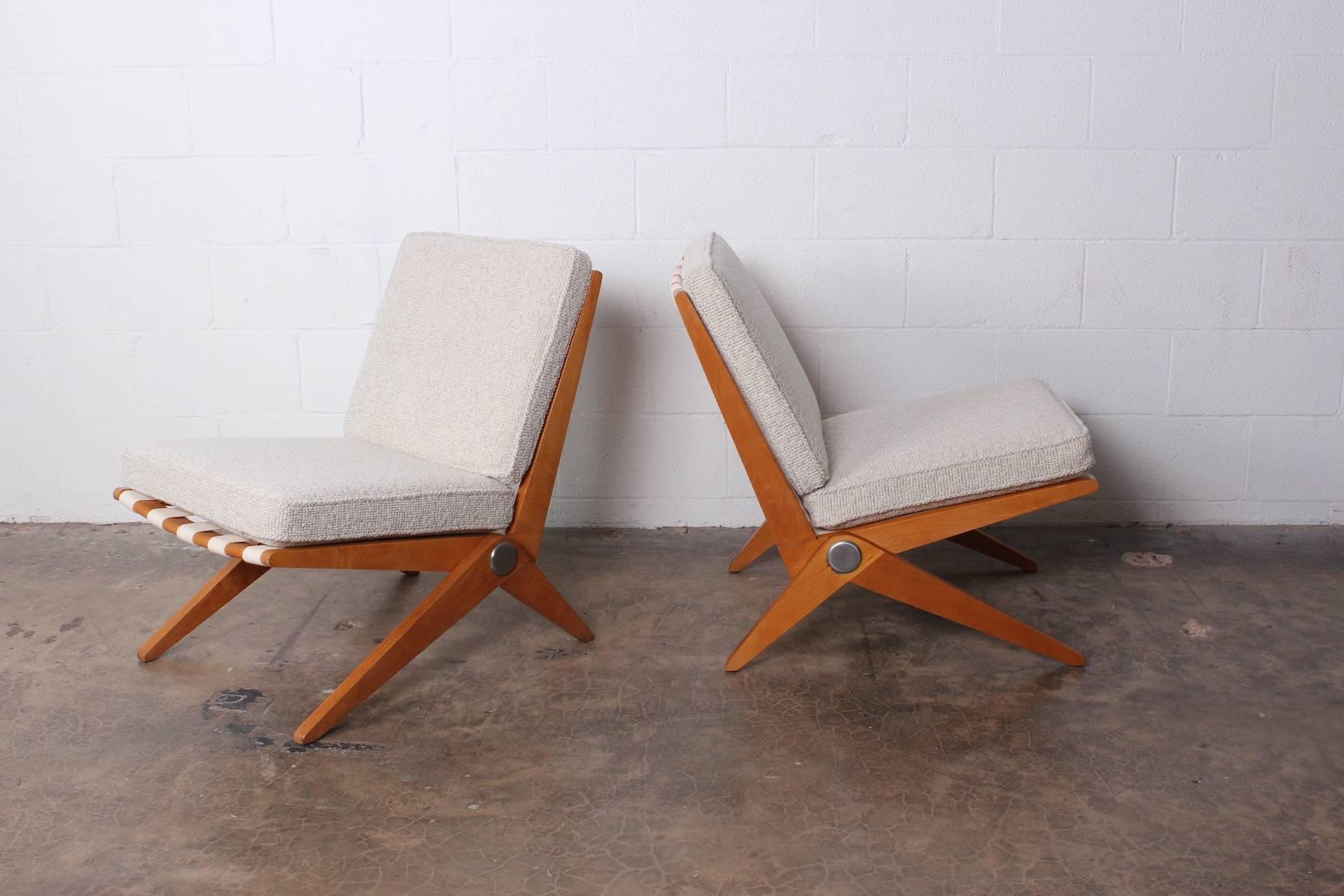 An early pair of knoll scissor chairs designed by Pierre Jeanneret.