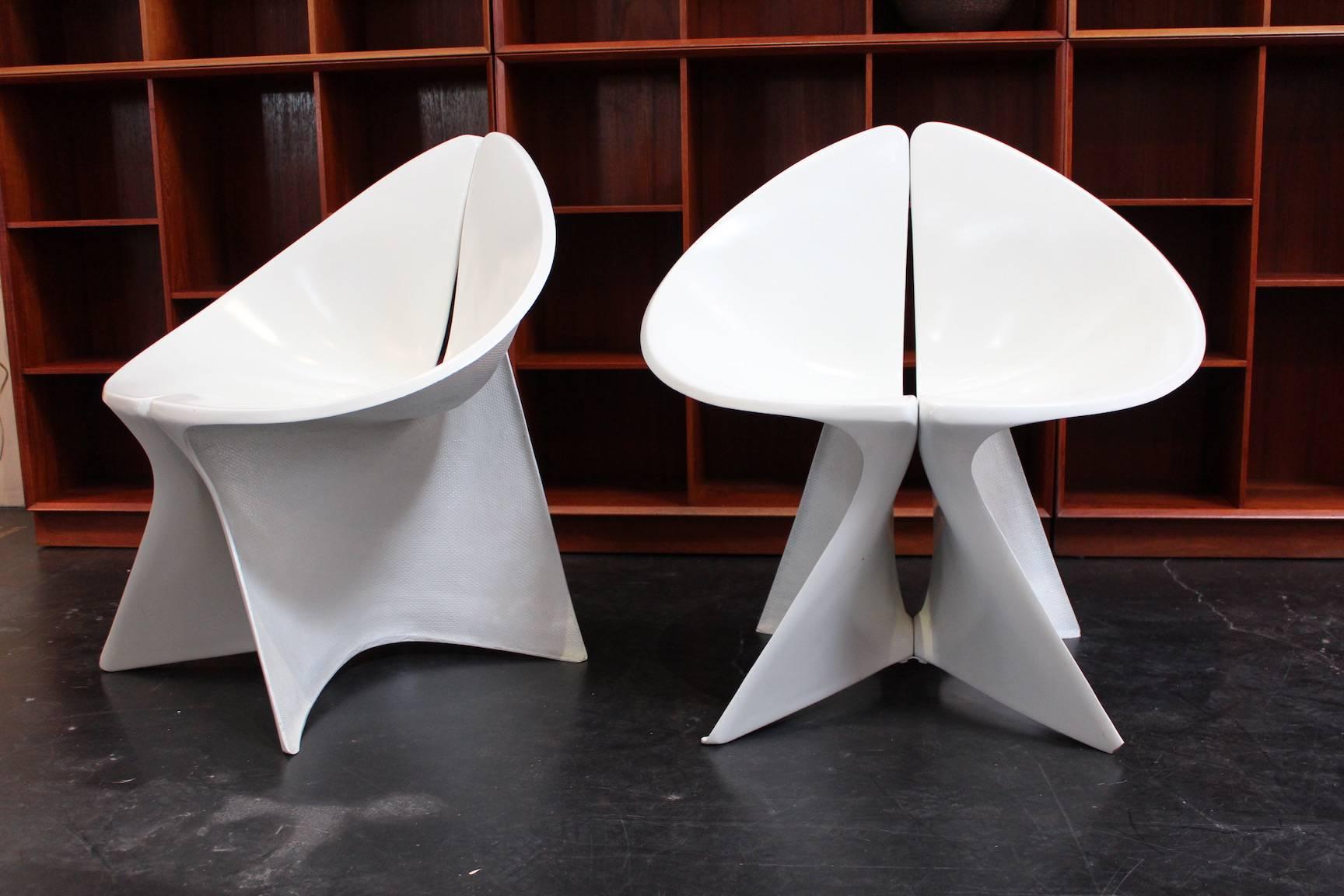 A pair of sculptural fiberglass lounge chairs.