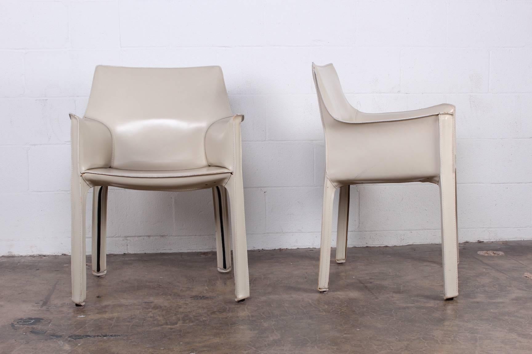 A set of ten cab armchairs in bone colored leather designed by Mario Bellini for Cassina.