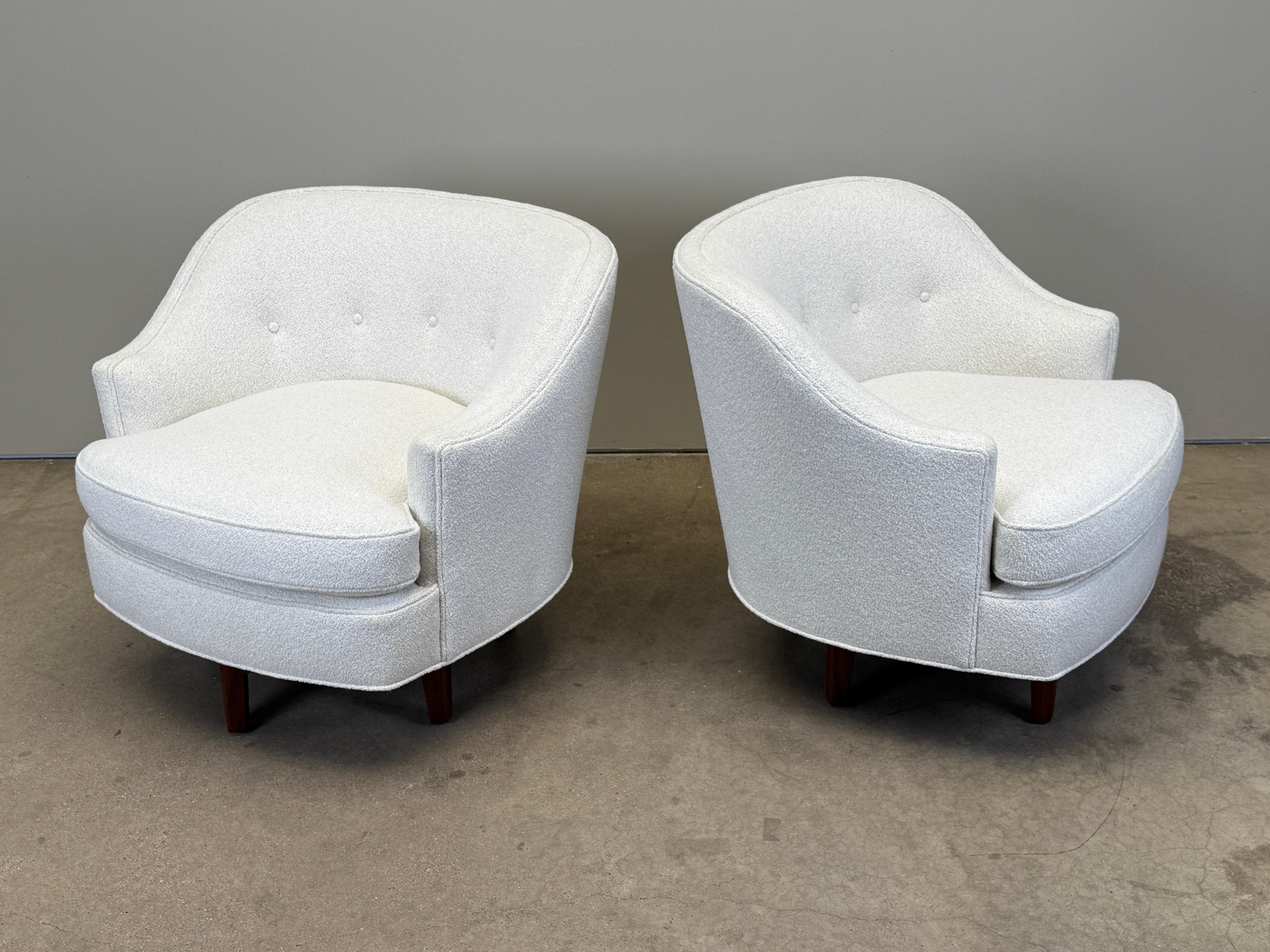 A pair of Edward Wormley for Dunbar swivel chairs with walnut bases reupholstered in Holly Hunt / Mokum / Sole Boucle / Seasalt fabric. 