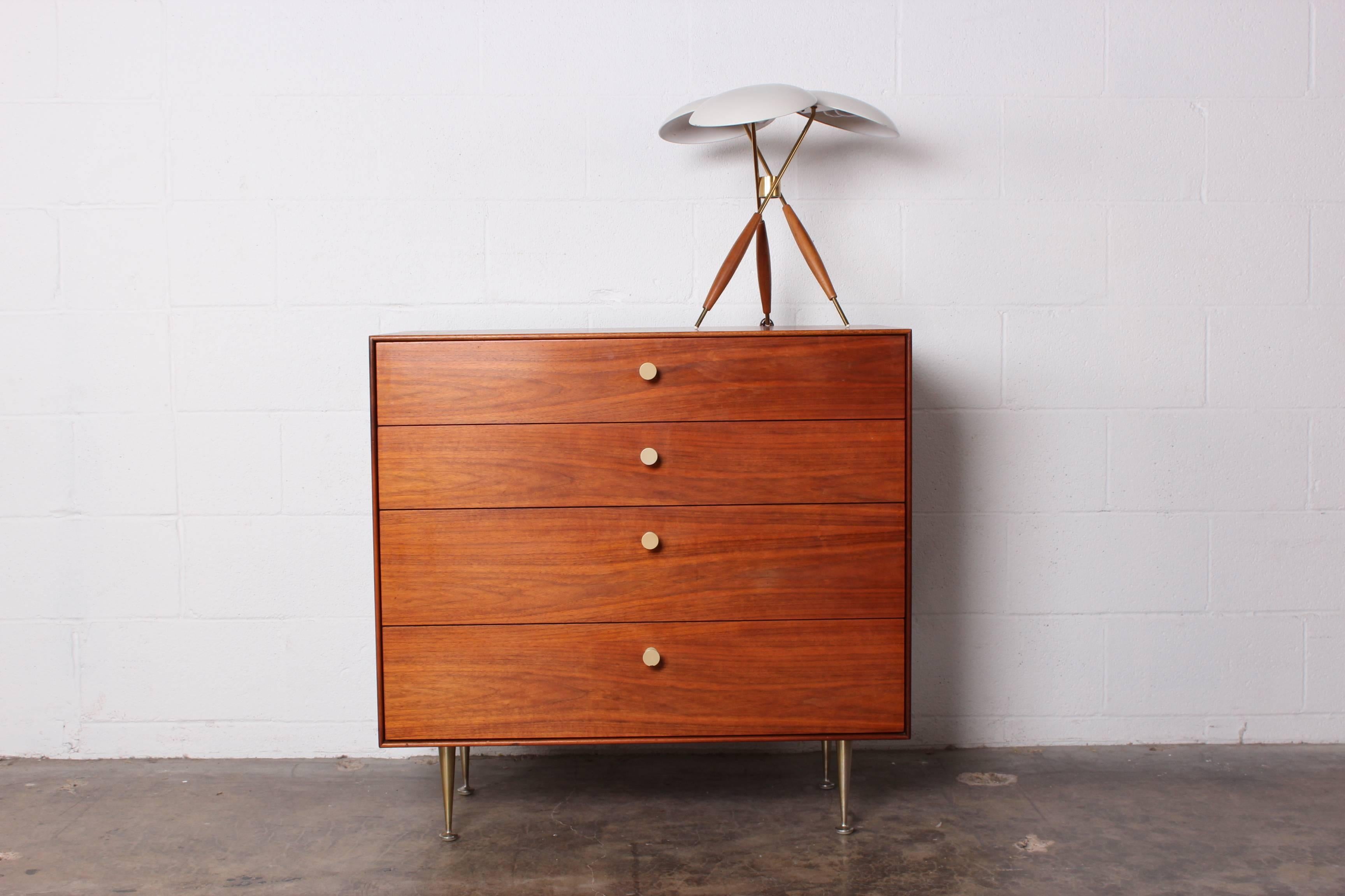 A teak thin edge dresser with original porcelain pulls and metal legs. Designed by George Nelson for Herman Miller.