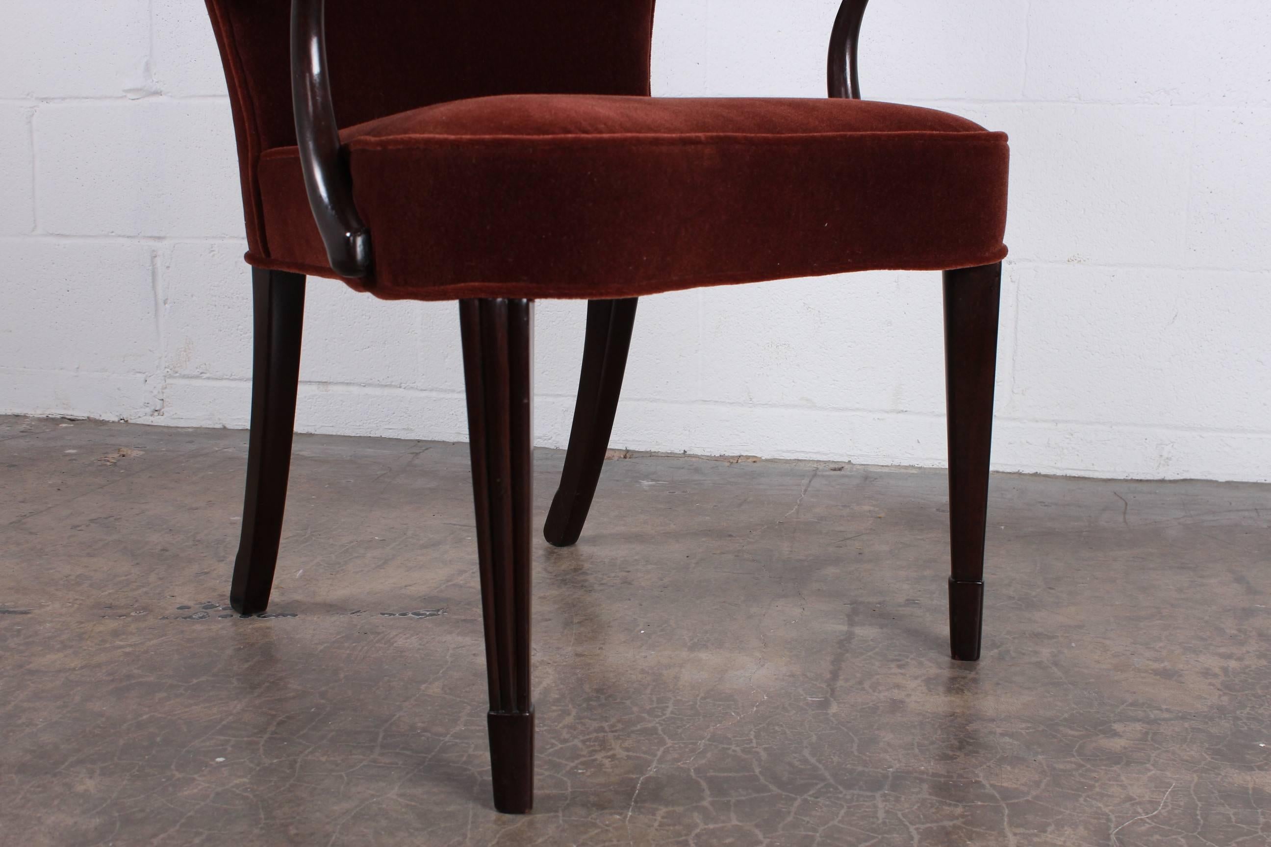 A pair of mahogany armchairs newly upholstered in rust mohair. Designed by Edward Wormley for Dunbar.