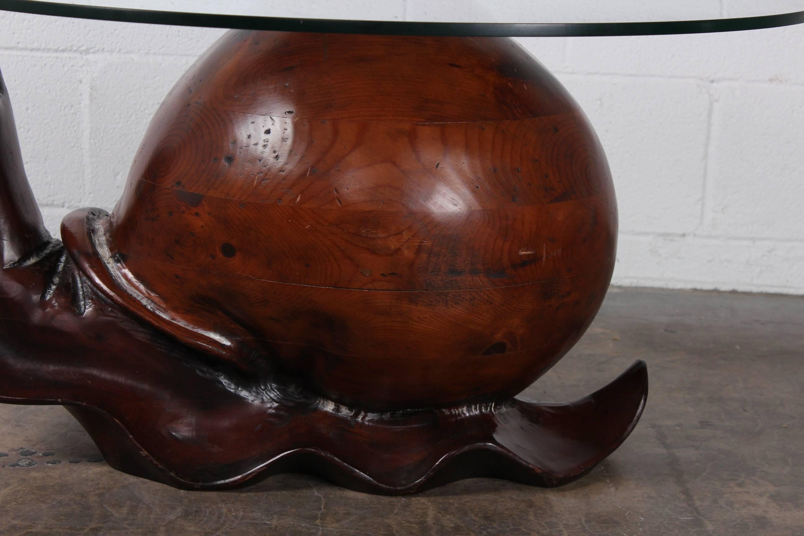 A hand-carved wooden snail table by Federico Armijo.