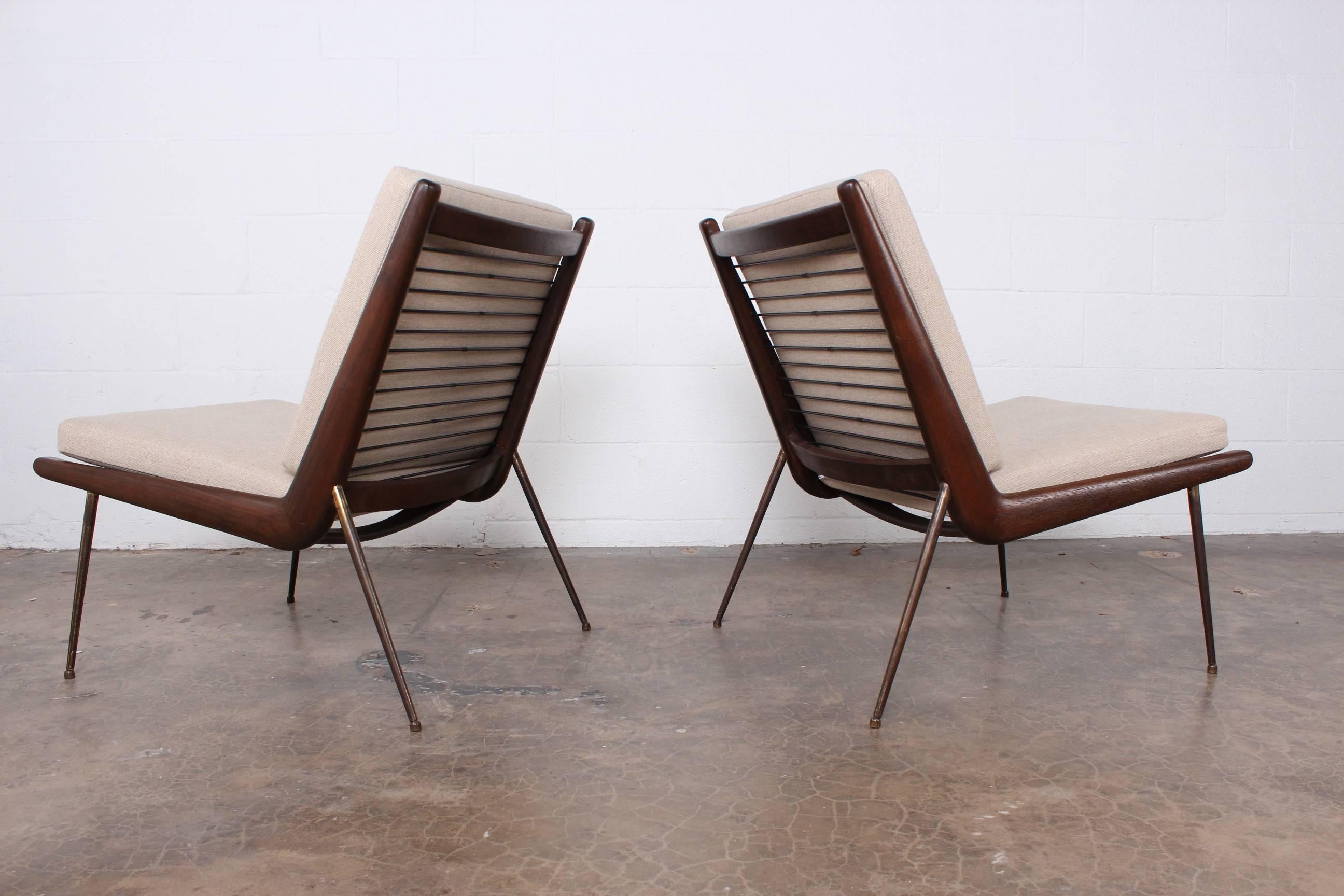 A pair of brass legged slipper chair designed by Peter Hvidt and Orla Mølgaard-Nielsen.