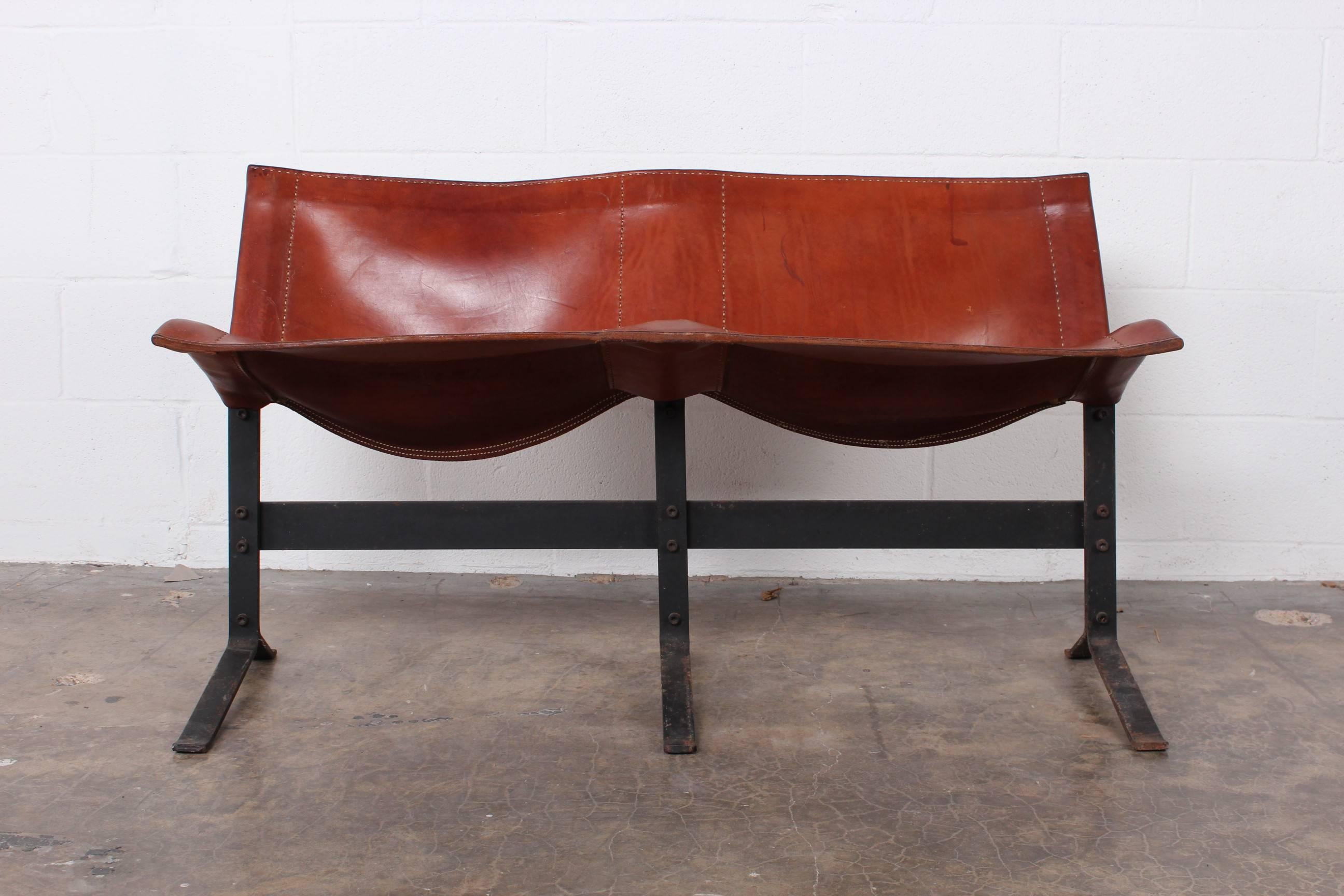 A beautifully patinated leather and iron bench by Max Gottschalk.