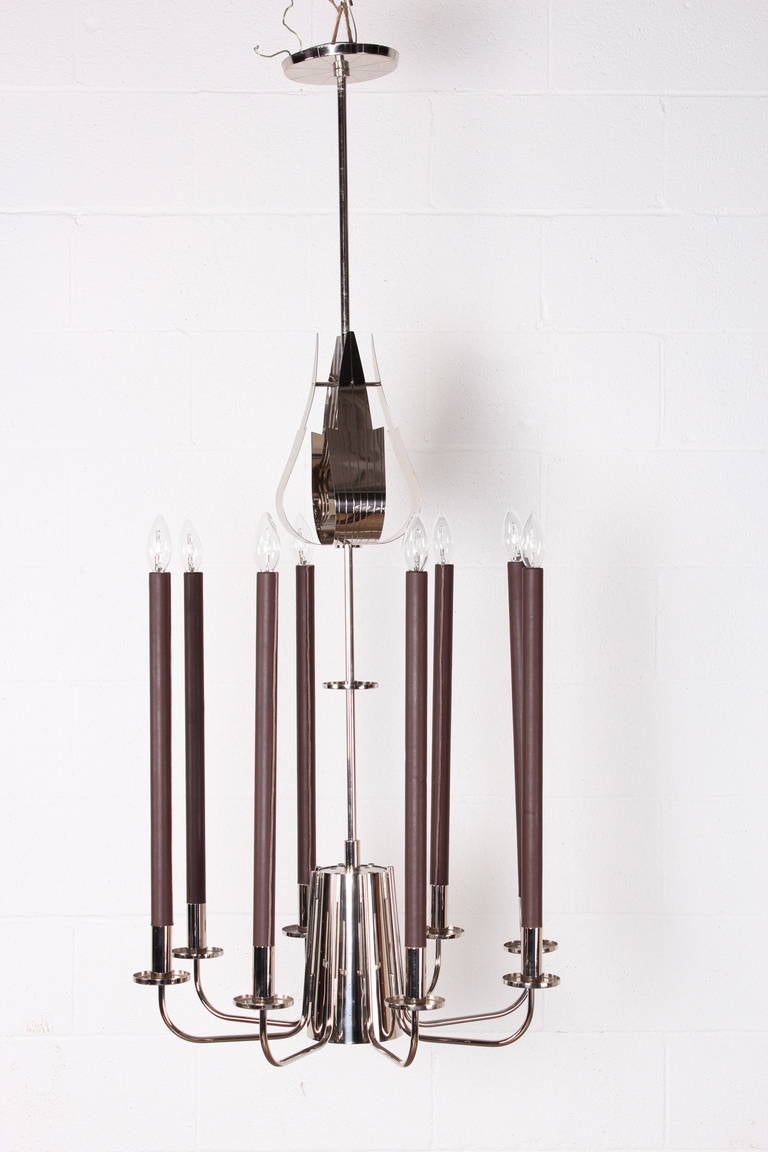 A rare and large design for Parzinger Originals. This model has eight leather wrapped candelabras and a larger down light with perforations in the central cone.