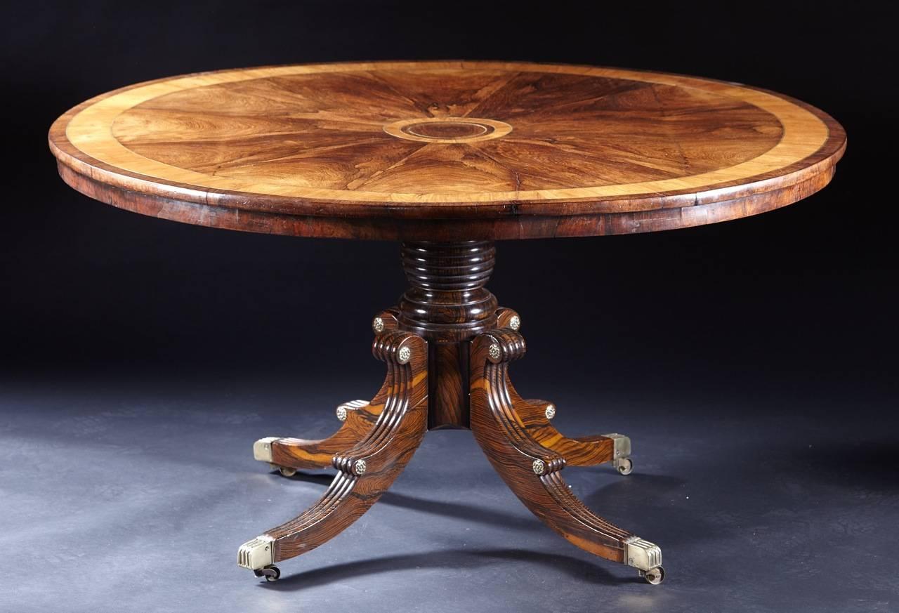 A fine brass inlaid Regency period rosewood tilt top center table. The finely figured top with brass inlay and crossbanding above a beautifully faux grained hipped knee, four-legged base ending in casters, English, circa 1815.