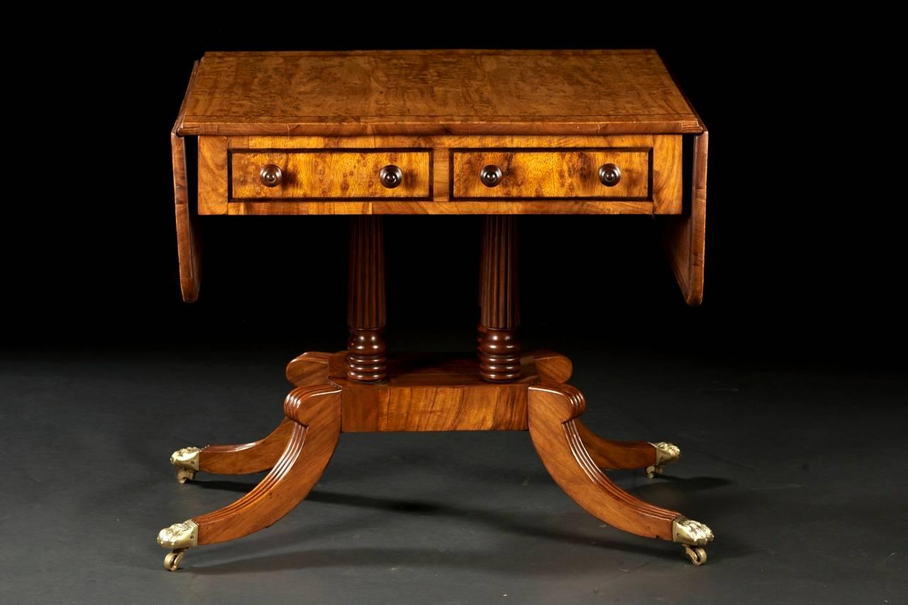 A pollard oak and mahogany sofa table from the Regency period. The top and frieze are constructed in desirable pollard oak and inlaid with rosewood stringing. The frieze contains two working drawers and two sham drawers on the opposing side. The
