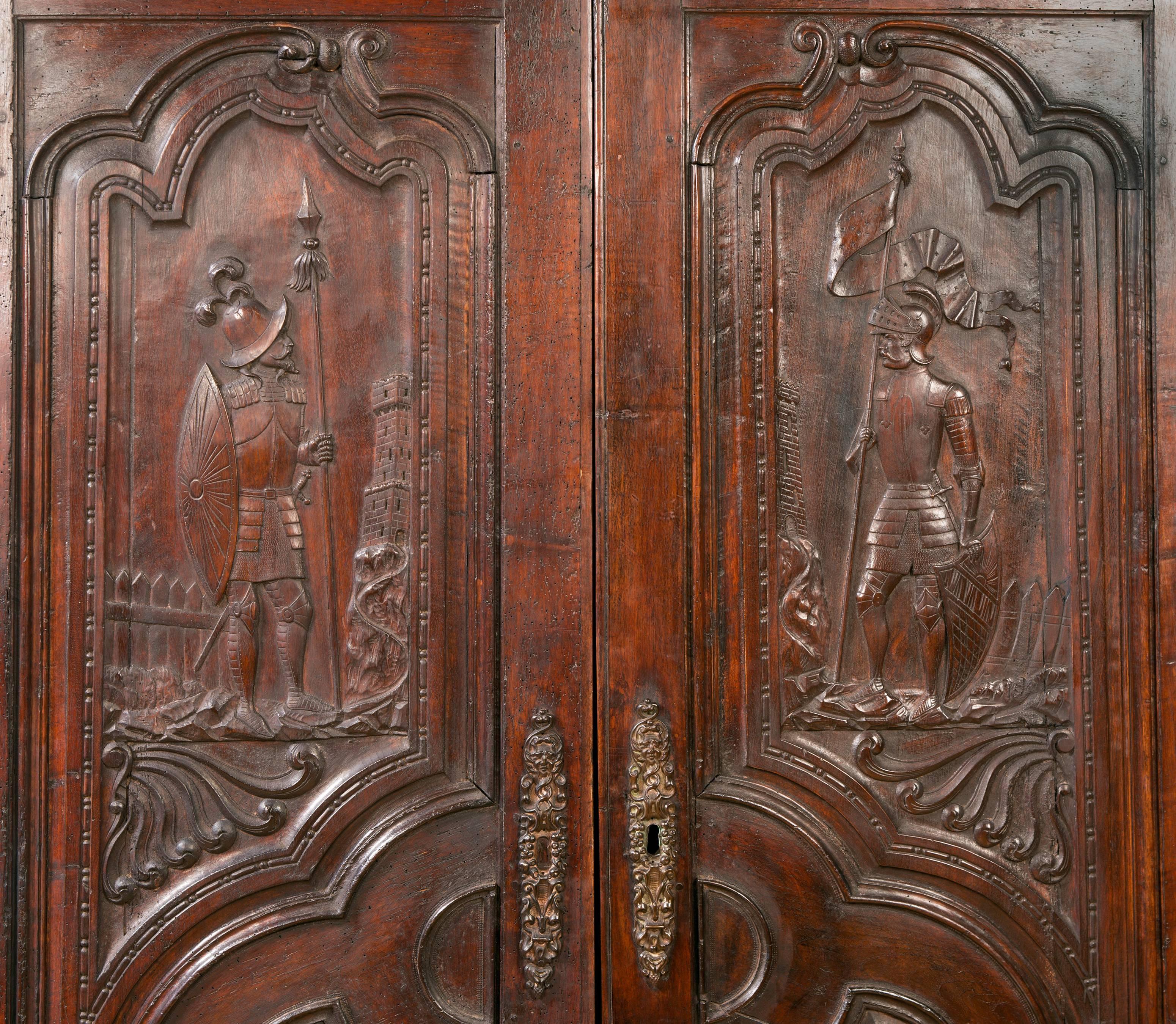 A unusual Spanish Armoire with relief carved doors depicting Conquistadors
on the top and coats of arms on the bottom. Probably made in the Border area of France in the Spanish Pyrenees.