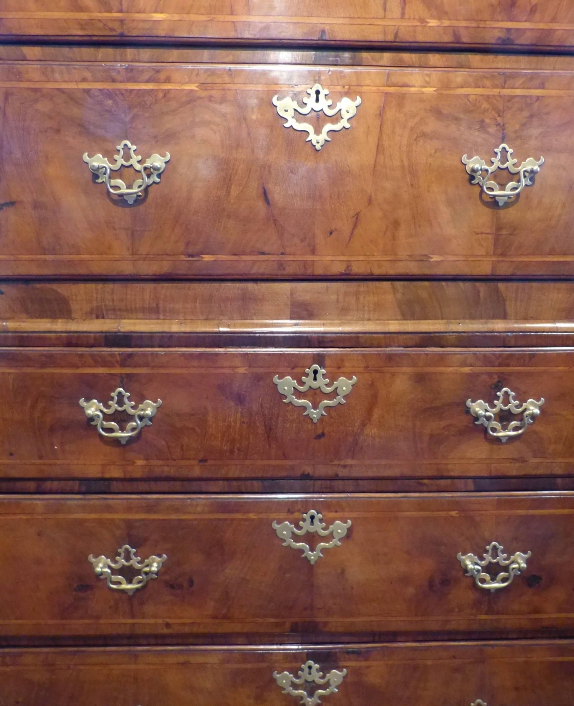 A good English inlaid figured walnut chest on chest, the top with canted fluted sides on bracket feet. The drawers with oak lining, circa 1740.