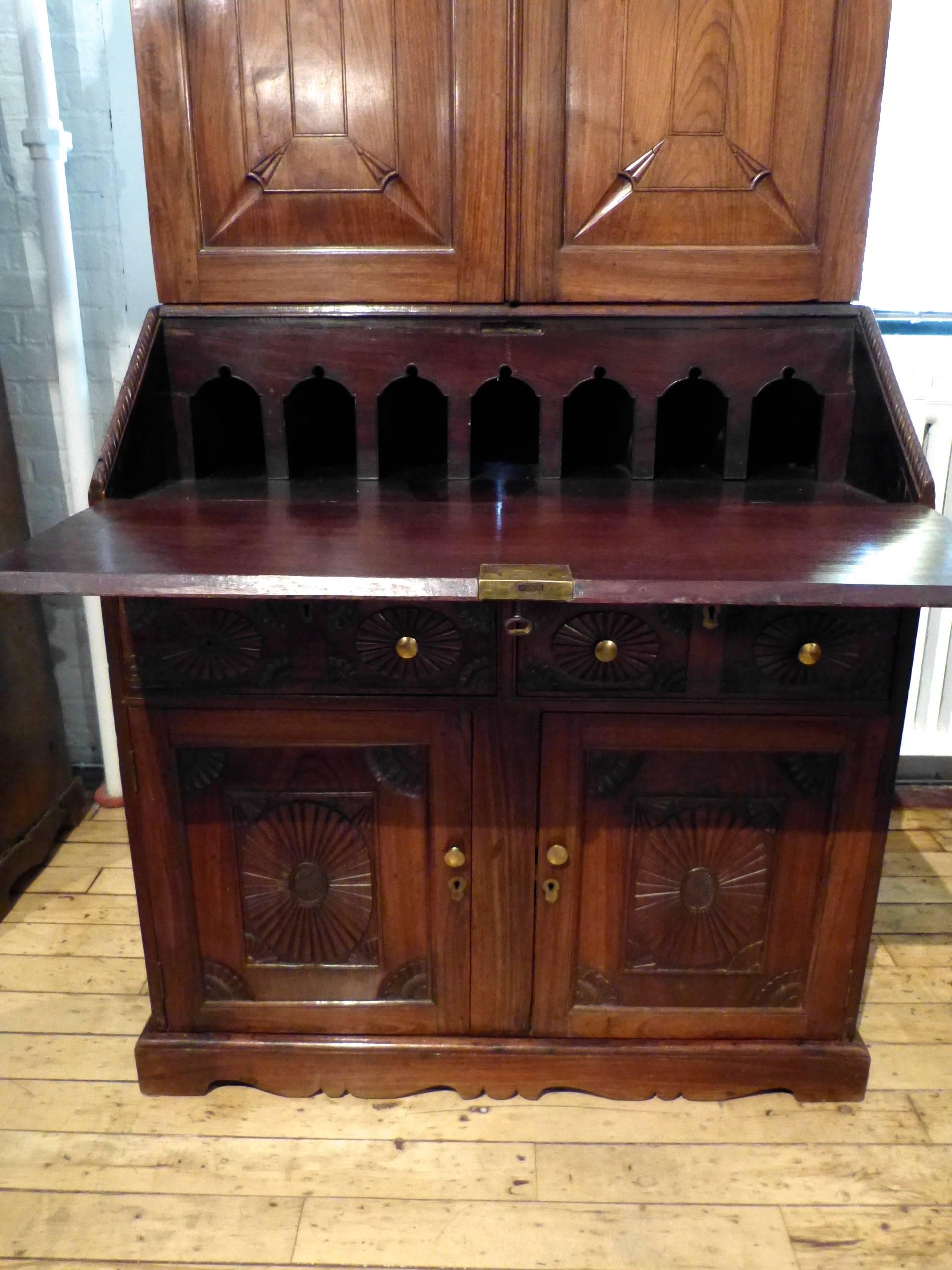 A good and highly decorated Padouk wood mid-19th century bureau cabinet with a fitted interior to the drop front and two drawers in the upper cabinet section, circa 1850.