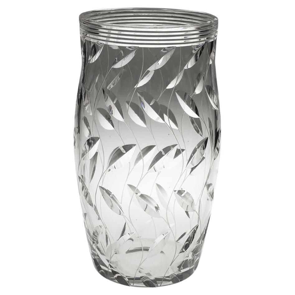 Heading : Leaf pattern vase
Date : 1937
Origin : England
Colour : Clear
Body : Prism cut rim with split cut leaves on engraved waving stems
Pattern : ‘Leaf’
Pontil : Polished
Base : Signed ‘Clyne Farquharson 37
Glass Type : Lead
Size : 24.8cm tall