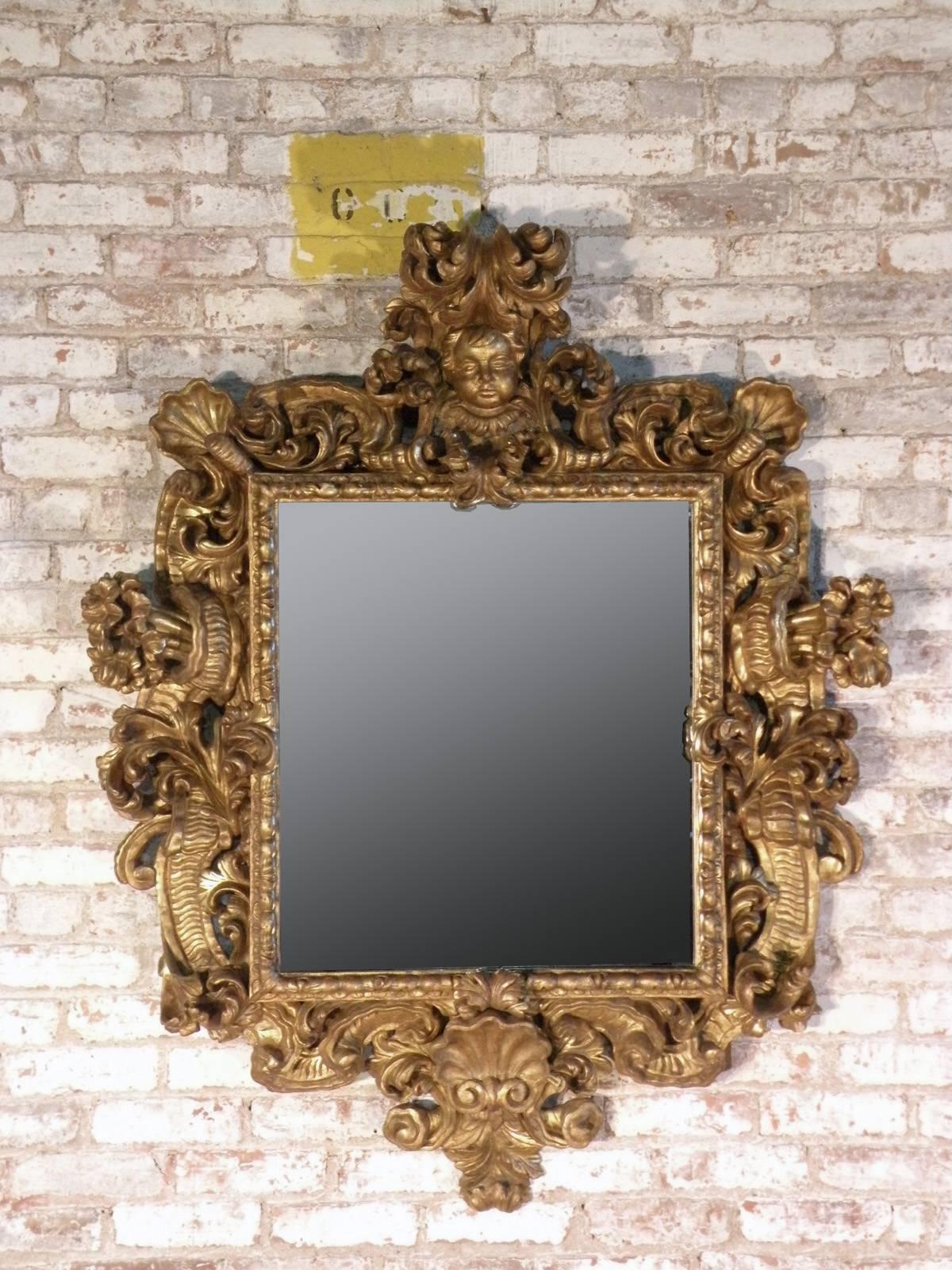 Exuberant Roman Baroque mirror, beautifully carved and gilt frame, later mirror plate.
