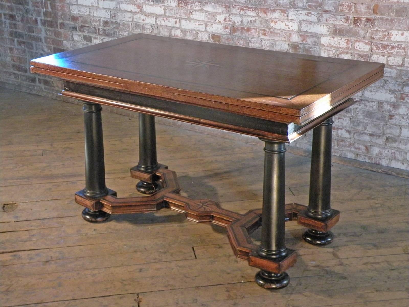 Dutch extension table of typical form. The top and each of the extension leaves feature an inlaid star in the center and linear inlay around the edge, conforming with the inlay on the double-Y stretcher.
The contrast of the blond oak with the ebony
