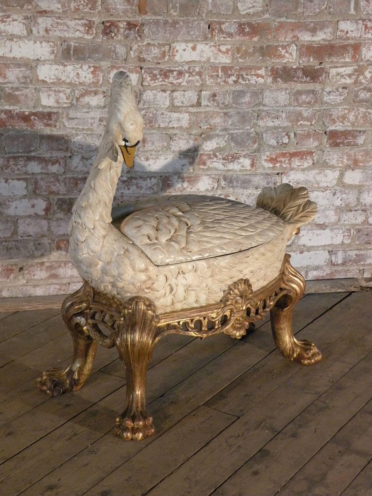 Extraordinary wine-cooler in the form of a beautifully sculpted, gilt and polychromed Swan of impressive stature, makes certainly the conversation-piece of the party. The white painted swan's body set into a gilt base with a decorative open carved