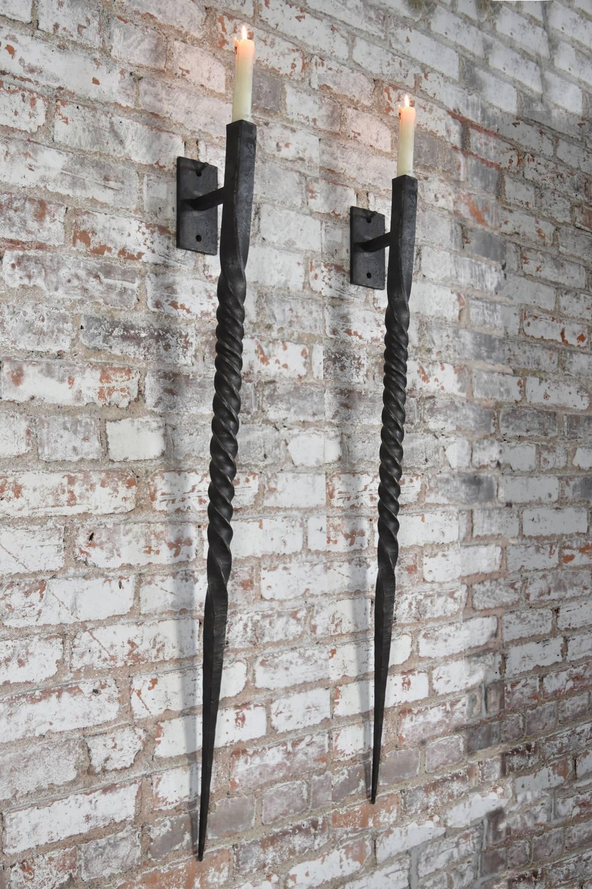 Large hand-forged twisted wrought iron wall sconces, timeless, bold and Stark appearance, exclusively designed for the Fortress, each sconce is individually hand-forged by local artisans; small variations in texture and size are a natural