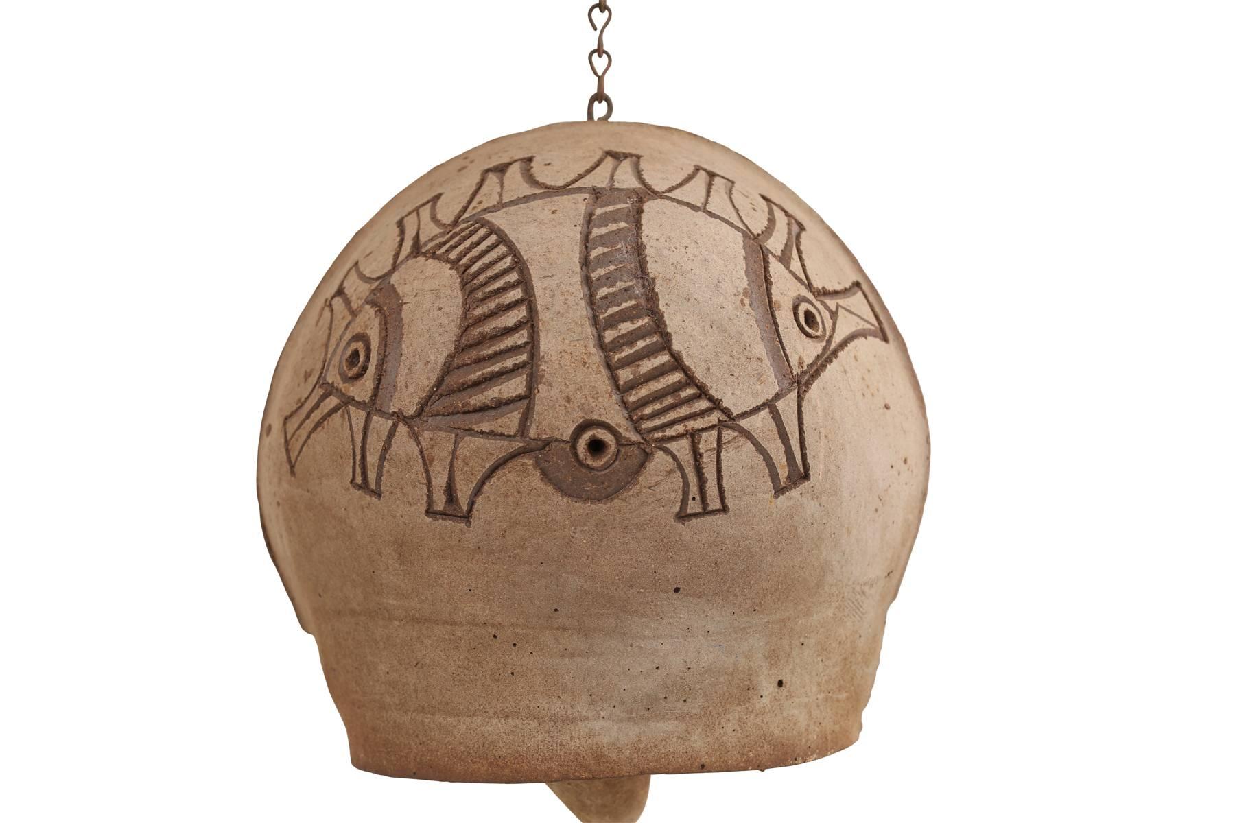 Paolo Soleri ceramic bell, circa early 1970s. This large scale example has an animal motif carved into each side. Measures: Height with chain is 27