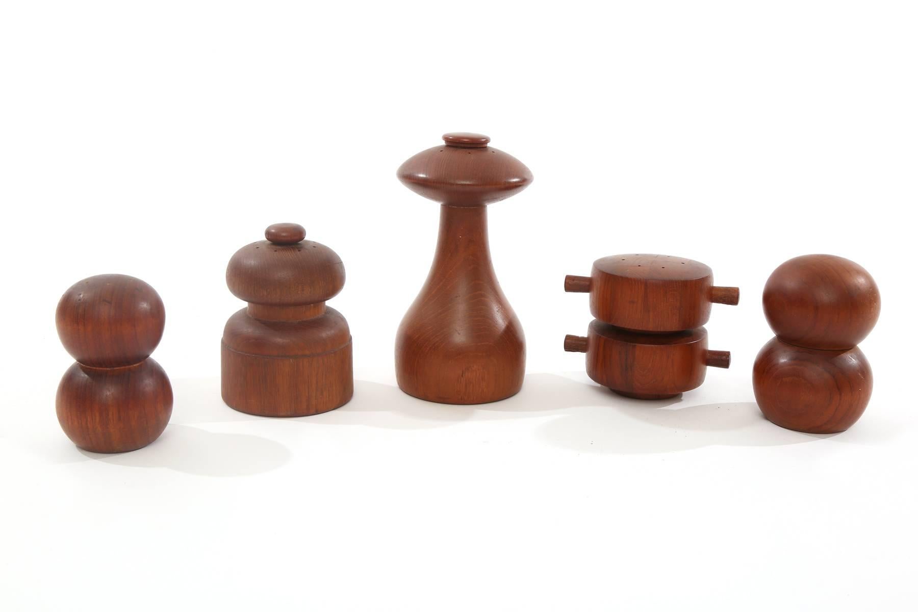 Grouping of early Dansk solid teak pepper mills, circa early 1960s. Smallest example measures 4